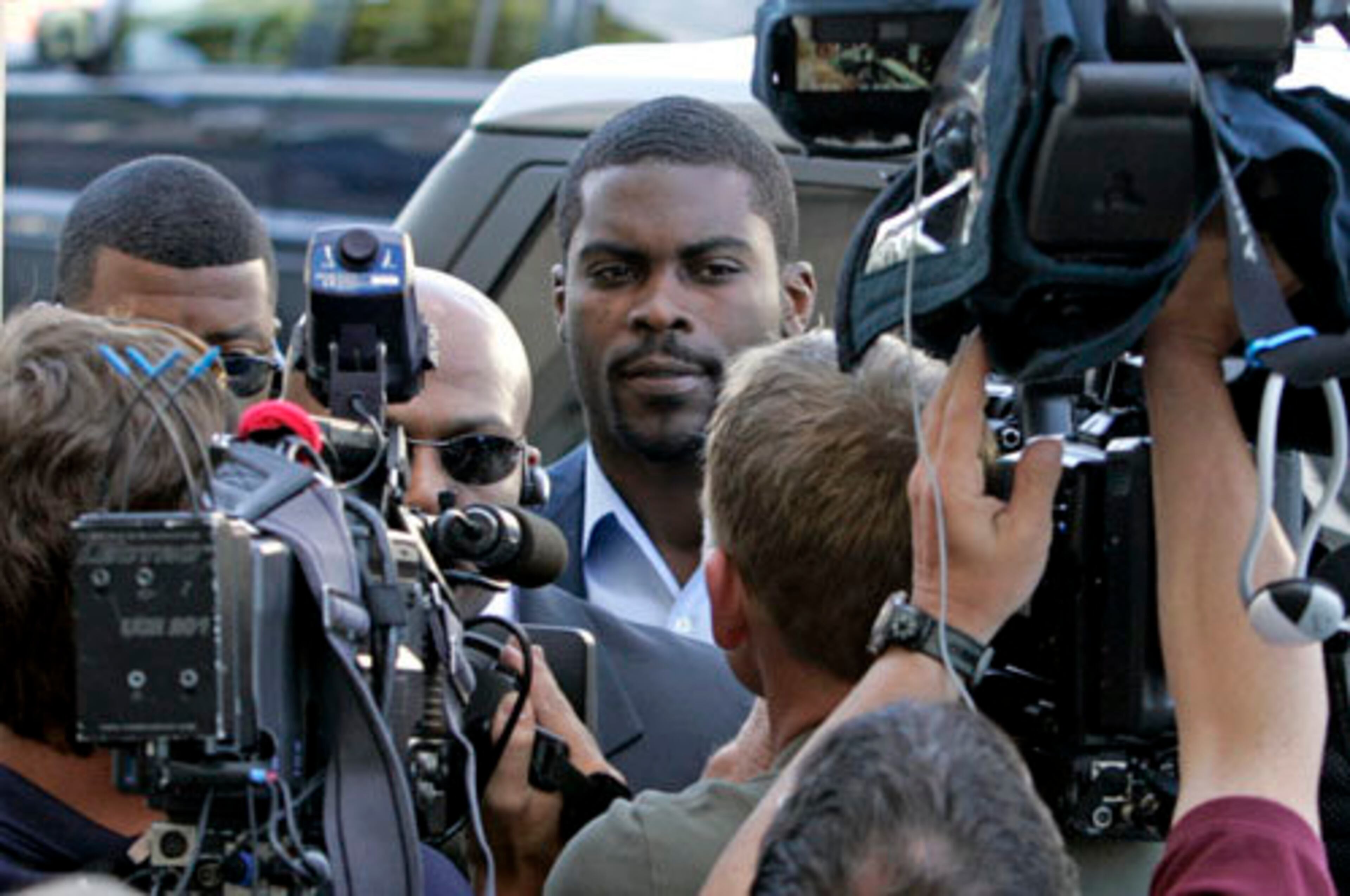Vick stepped out of the vehicle near the front door of the courthouse and walked silently past waiting cameras and reporters, ignoring questions about his first day home and his plans.