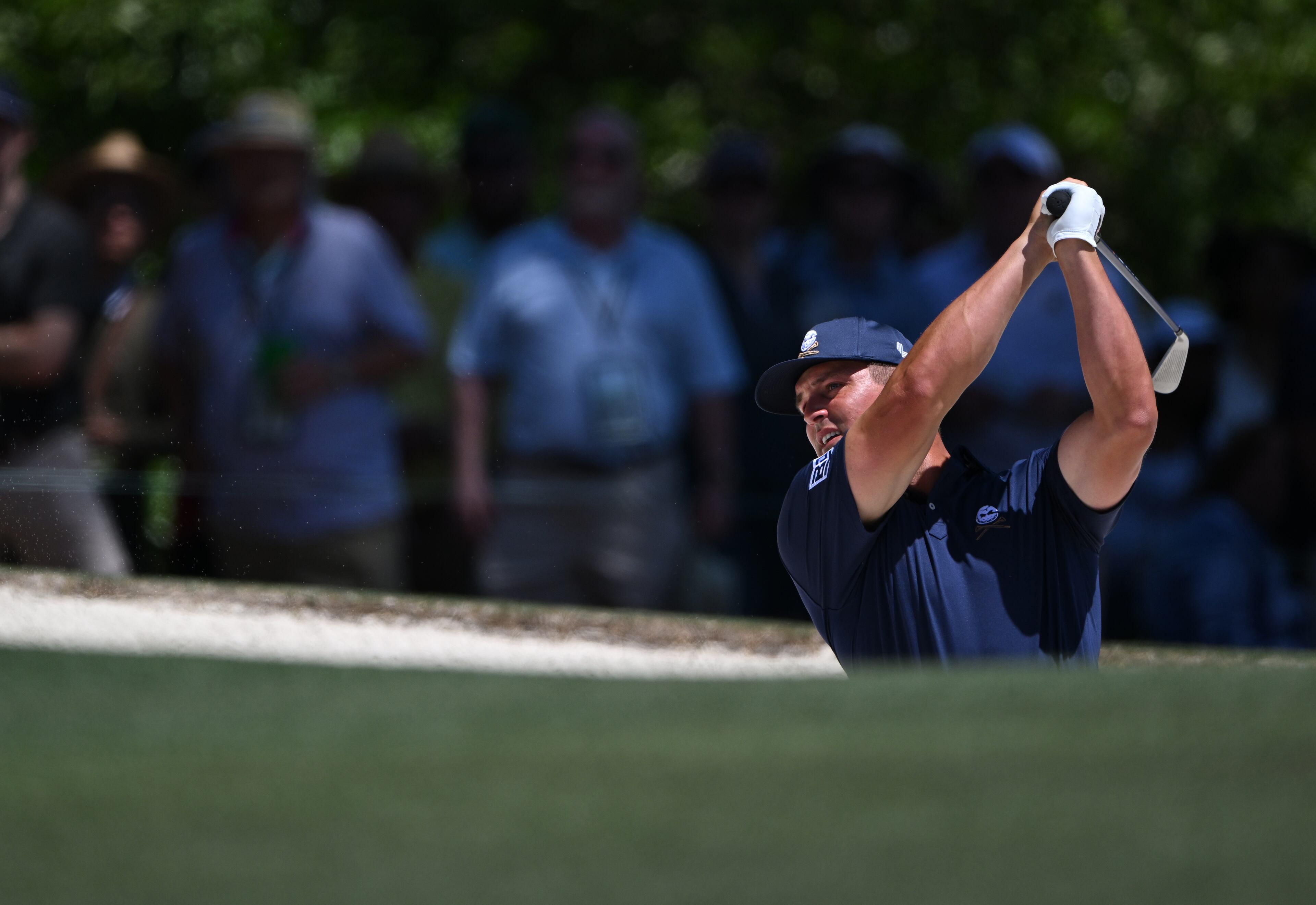 Bryson DeChambeau hits out of bunker on first hole during the final round of the 2024 Masters Tournament at Augusta National Golf Club, Sunday, April 14, 2024, in Augusta, Ga. (Hyosub Shin / Hyosub.Shin@ajc.com)