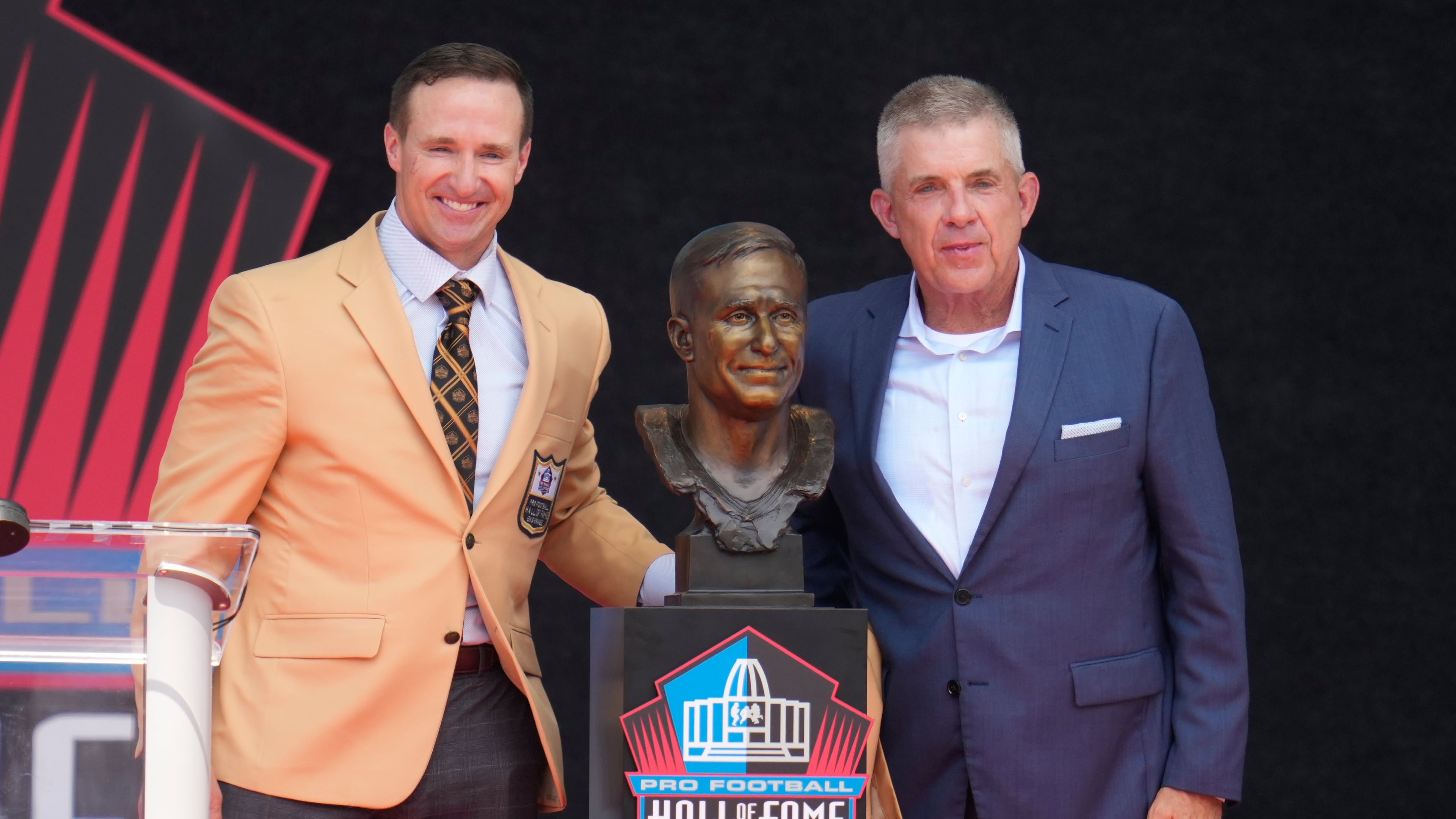 Former NFL player Drew Brees, left, unveils his bust with Sean Payton during the Pro Football Hall of Fame induction ceremony at the Pro Football Hall of Fame, in Canton, Ohio, Saturday, Aug. 8, 2026. (AP Photo/Sue Ogrocki)