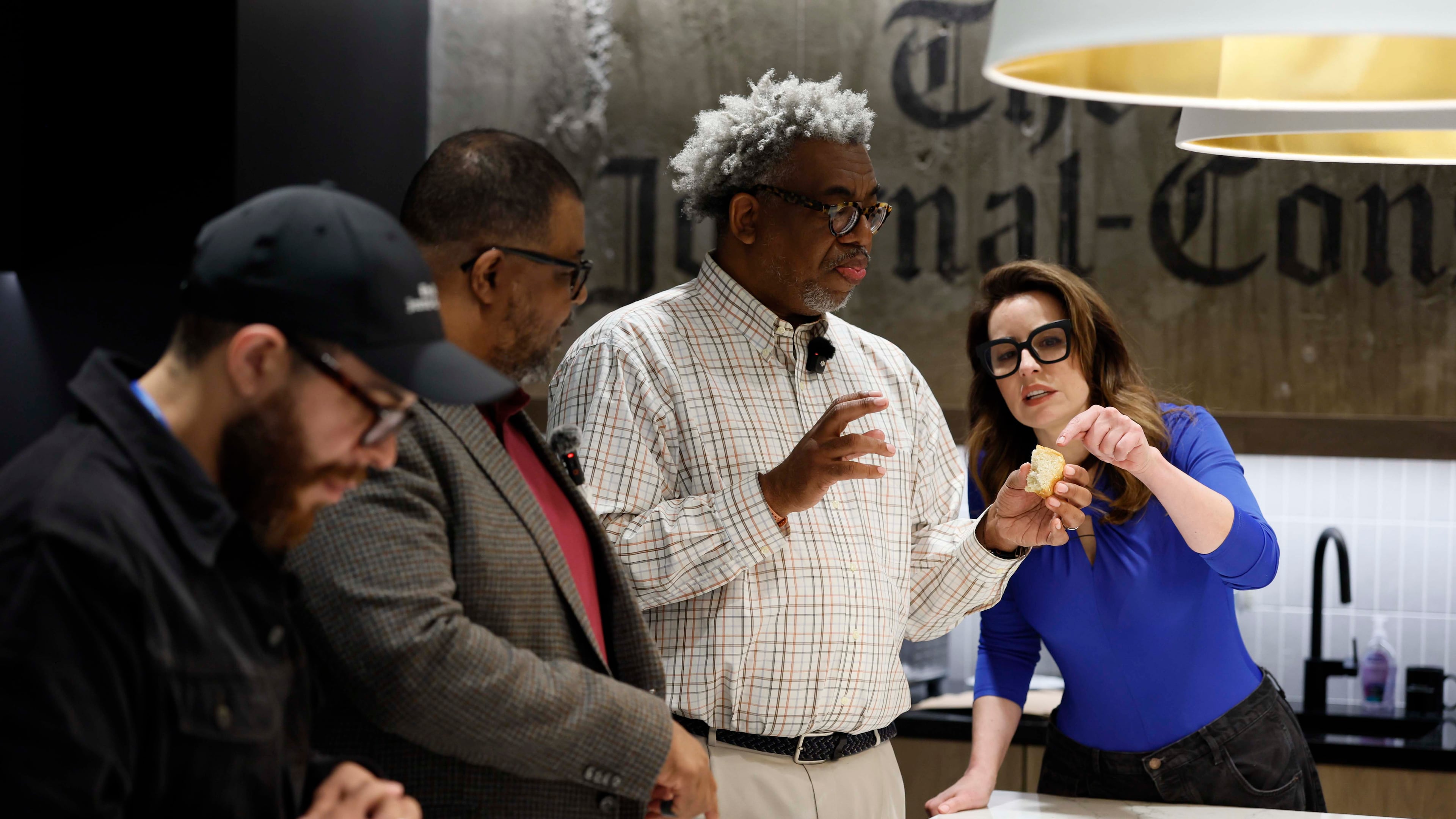 AJC Senior Food & Dining Editor Monti Carlo, right, helps Race and Culture Reporter Ernie Suggs analyze the flavors of a biscuit, while AJC Editor-in-Chief Leroy Chapman Jr. and Director of Social Media Travis Lyles enjoy them during a tasting contest to find the best biscuit in Atlanta on Tuesday, April 28, 2026. (Miguel Martinez/AJC)