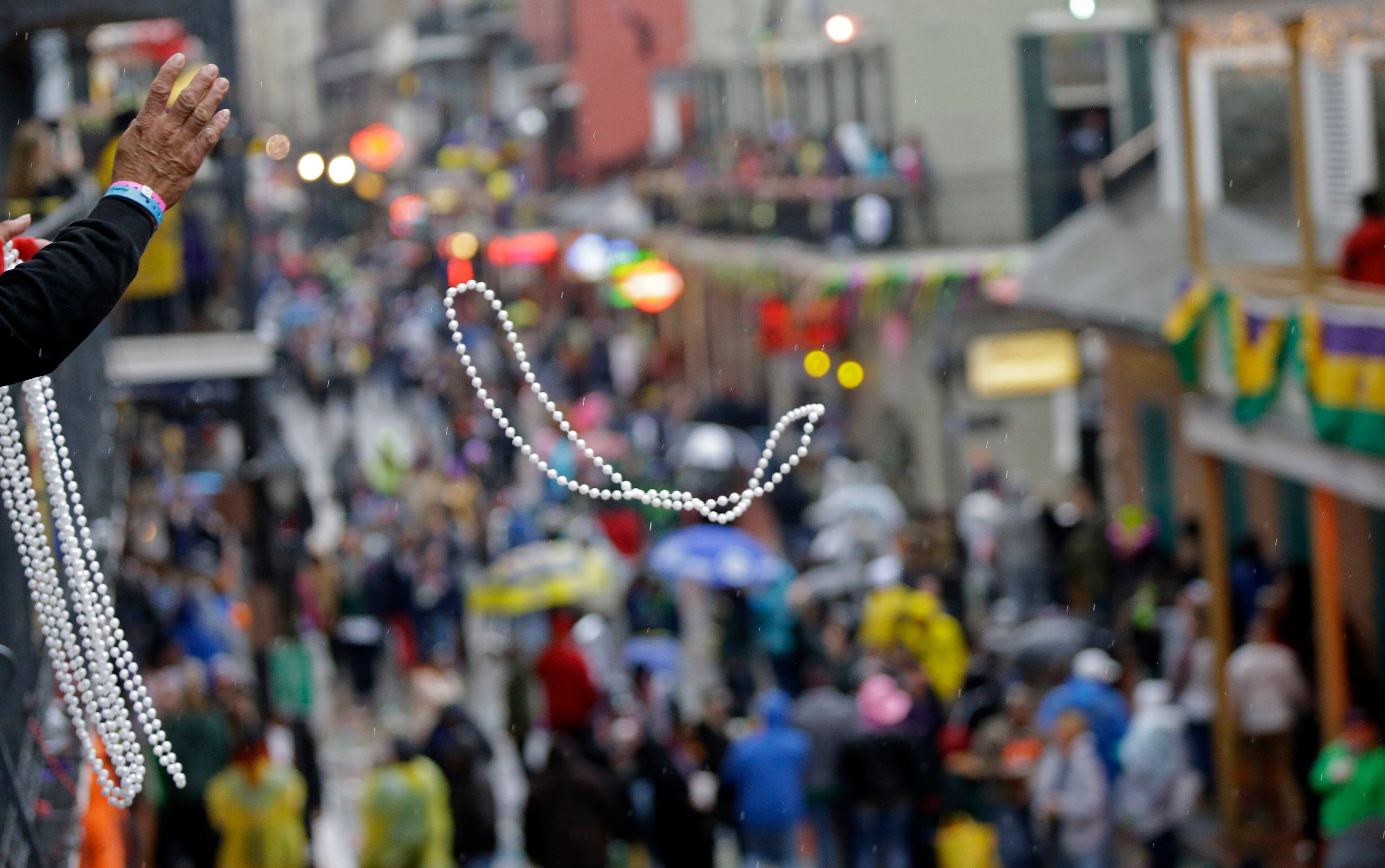 Mardi Gras crowds in the French Quarter are seen in the rain from the balcony of the Royal Sonesta Hotel in New Orleans, Tuesday, March 4, 2014. Rain and unusually cold temperatures kept much of the normally massive and festive crowds away. (AP Photo/Gerald Herbert)