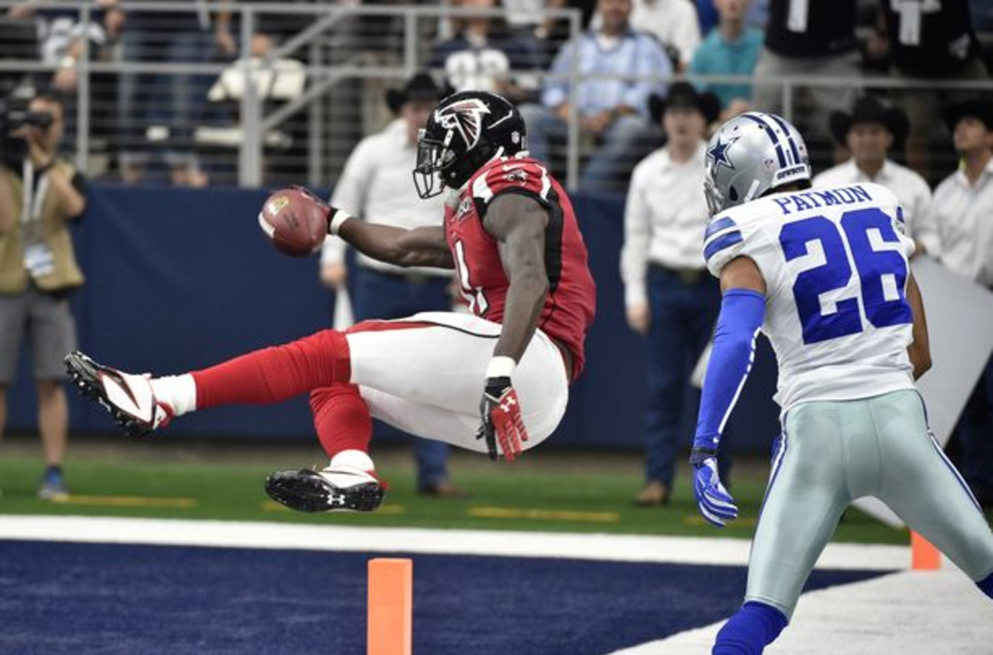 Atlanta Falcons wide receiver Julio Jones (11) sails into the end zone for a touchdown as Dallas Cowboys defensive back Tyler Patmon (26) watches in the second half of an NFL football game in Arlington, Texas. (AP Photo/Michael Ainsworth)