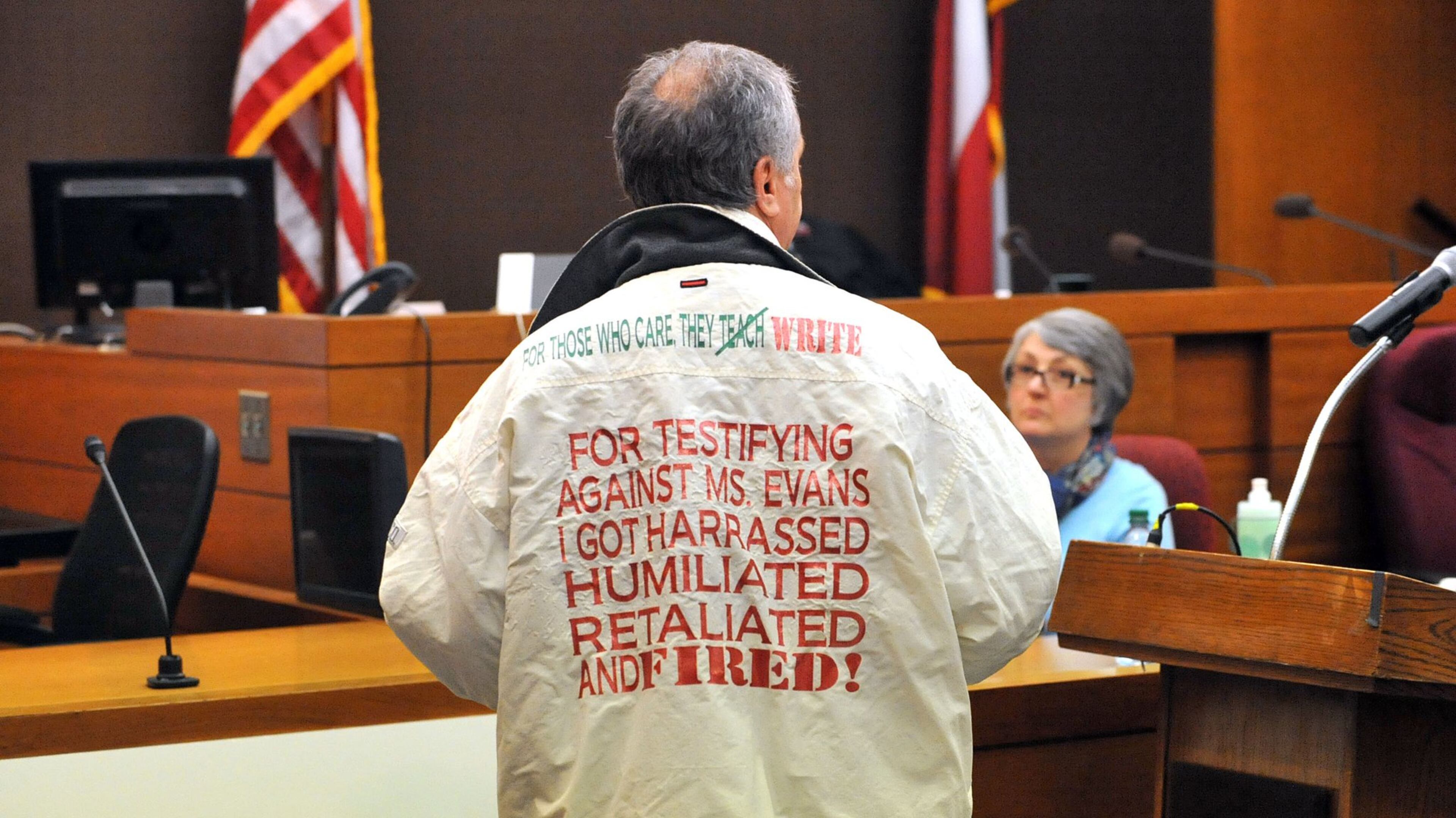 Defense attorney Robert Rubin dons a jacket once worn by a witness who testified against his client, former Dobbs Elementary principal Dana Evans, during his closing argument Monday afternoon in the Atlanta Public Schools test-cheating trial. Rubin said the allegations on the jacket were part of the public shaming of his client during the course of the trial. The jacket first surfaced in the trial in January, when former Dobbs paraprofessional Naomi Williams testified that in 2009 she was fired within days of telling Evans that a teacher had asked her to change answers on a student’s standardized test. Williams testified that before she was fired, she filed complaints with the school district. And she said that in 2010, she wore a special jacket to a public meeting with the APS superintendent that bore this message on the back: “For testifying against Ms. Evans, I got harassed, humiliated, retaliated and fired.” (Kent D. Johnson, The Atlanta Journal-Constitution)