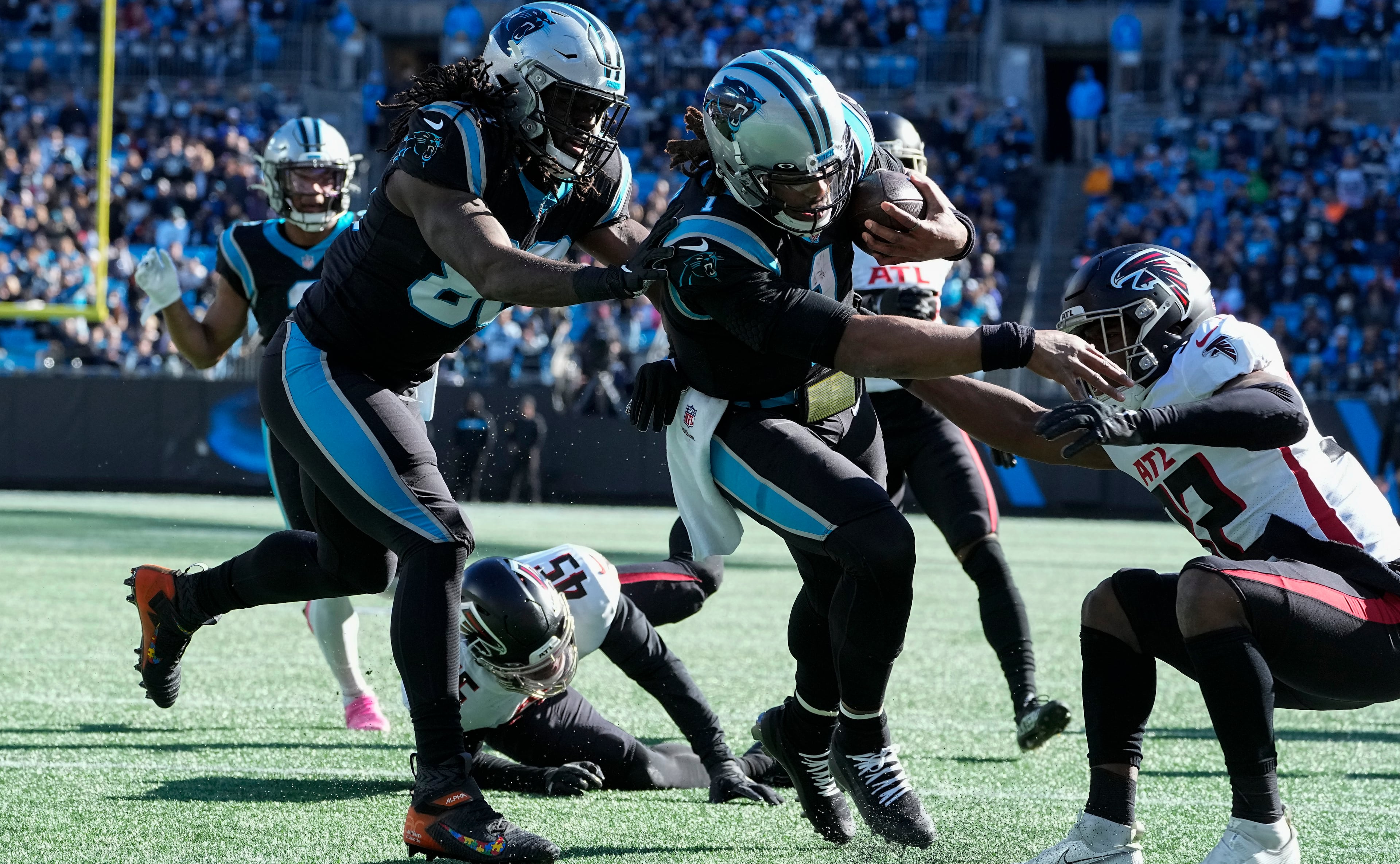 Panthers quarterback Cam Newton runs for a touchdown during the first quarter of Sunday's game against the Falcons in Charlotte. (AP Photo/John Bazemore)