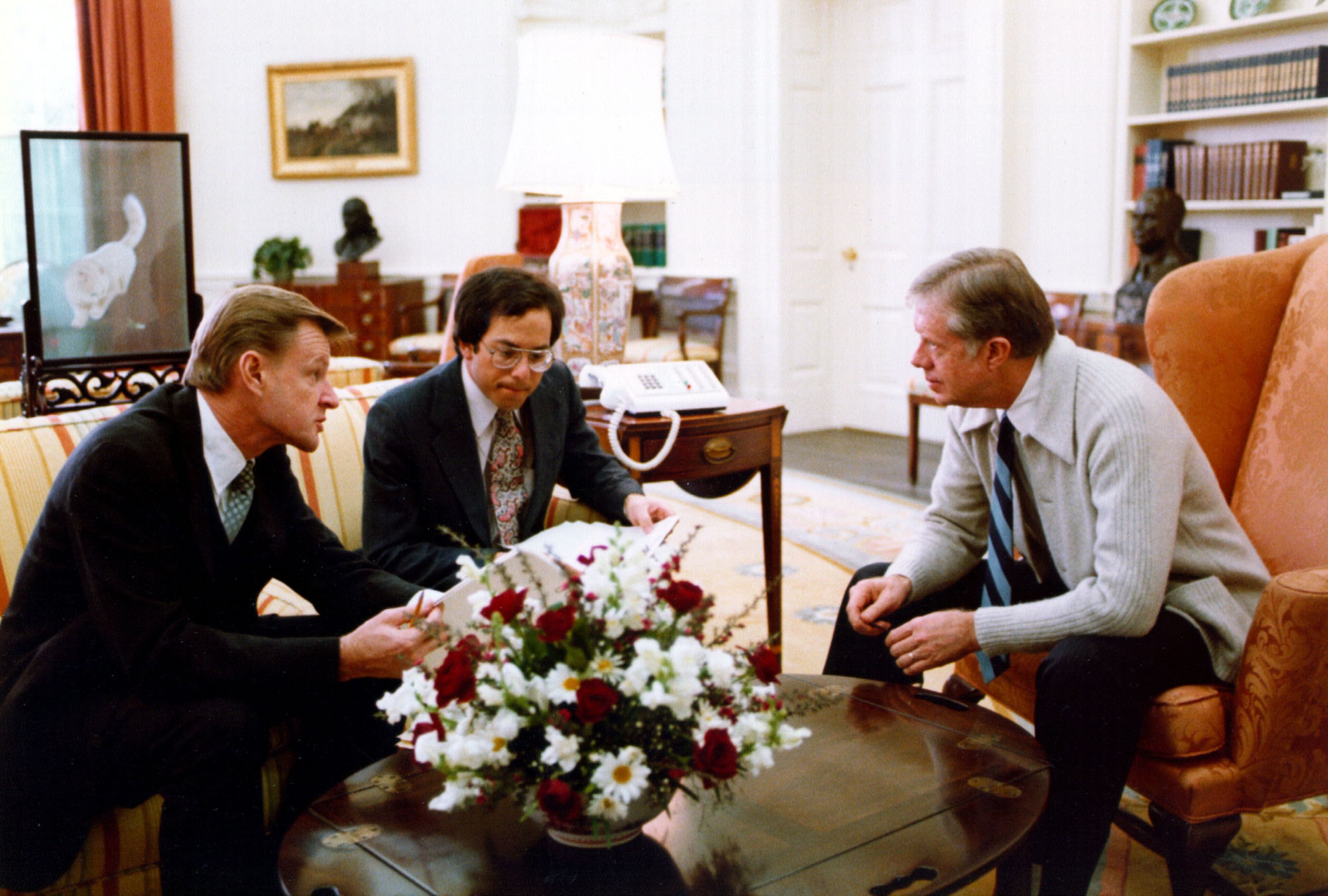 President Jimmy Carter meets with National Security Advisor Zbigniew Brzezinski, left, and Bob Pastor in the Oval Office on Jan. 3, 1980. (White House Staff Photographers)
