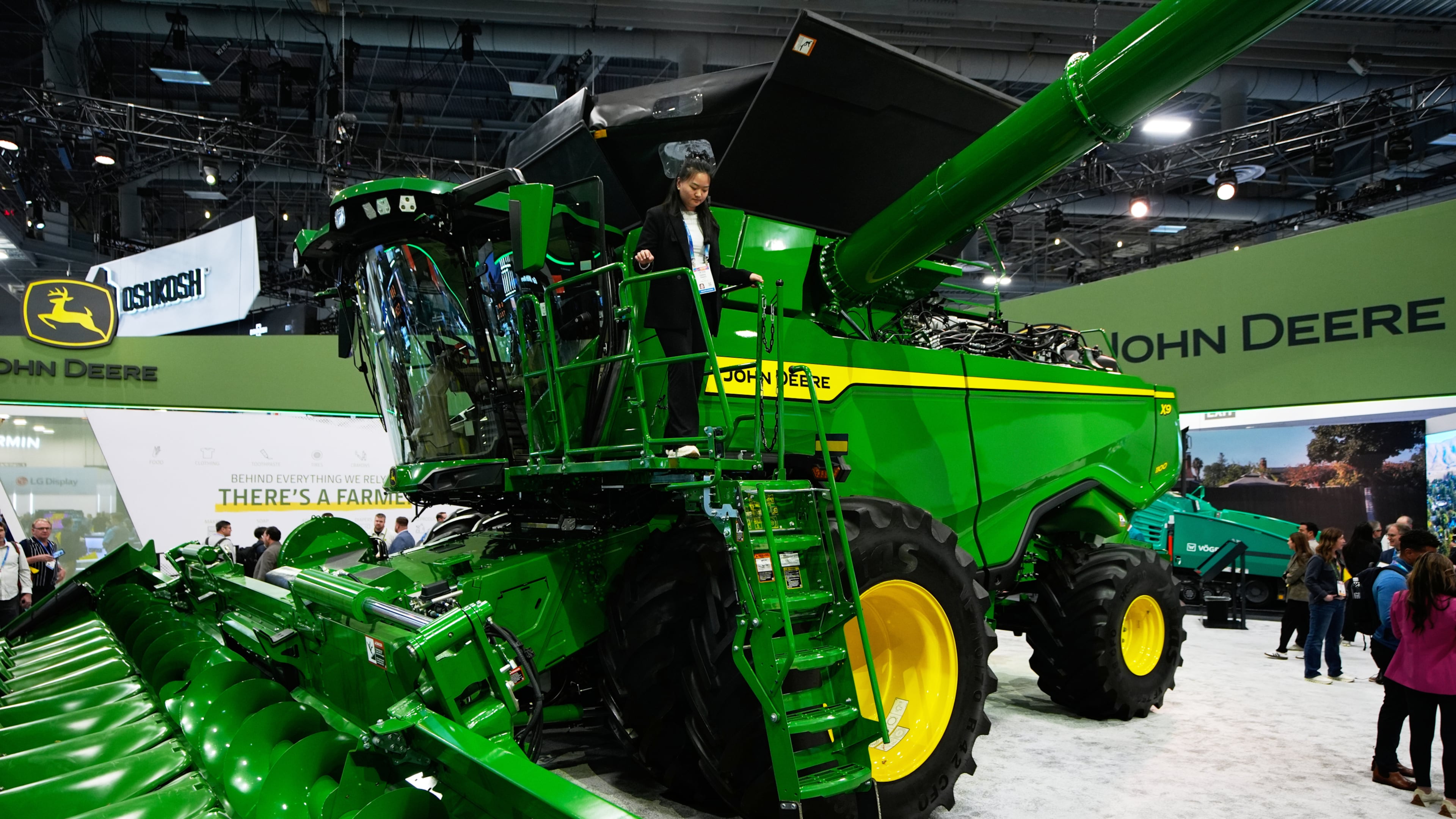 FILE - A person walks on an X9 1100 combine at the John Deere booth during the CES tech show, Jan. 6, 2026, in Las Vegas. (AP Photo/John Locher, File)