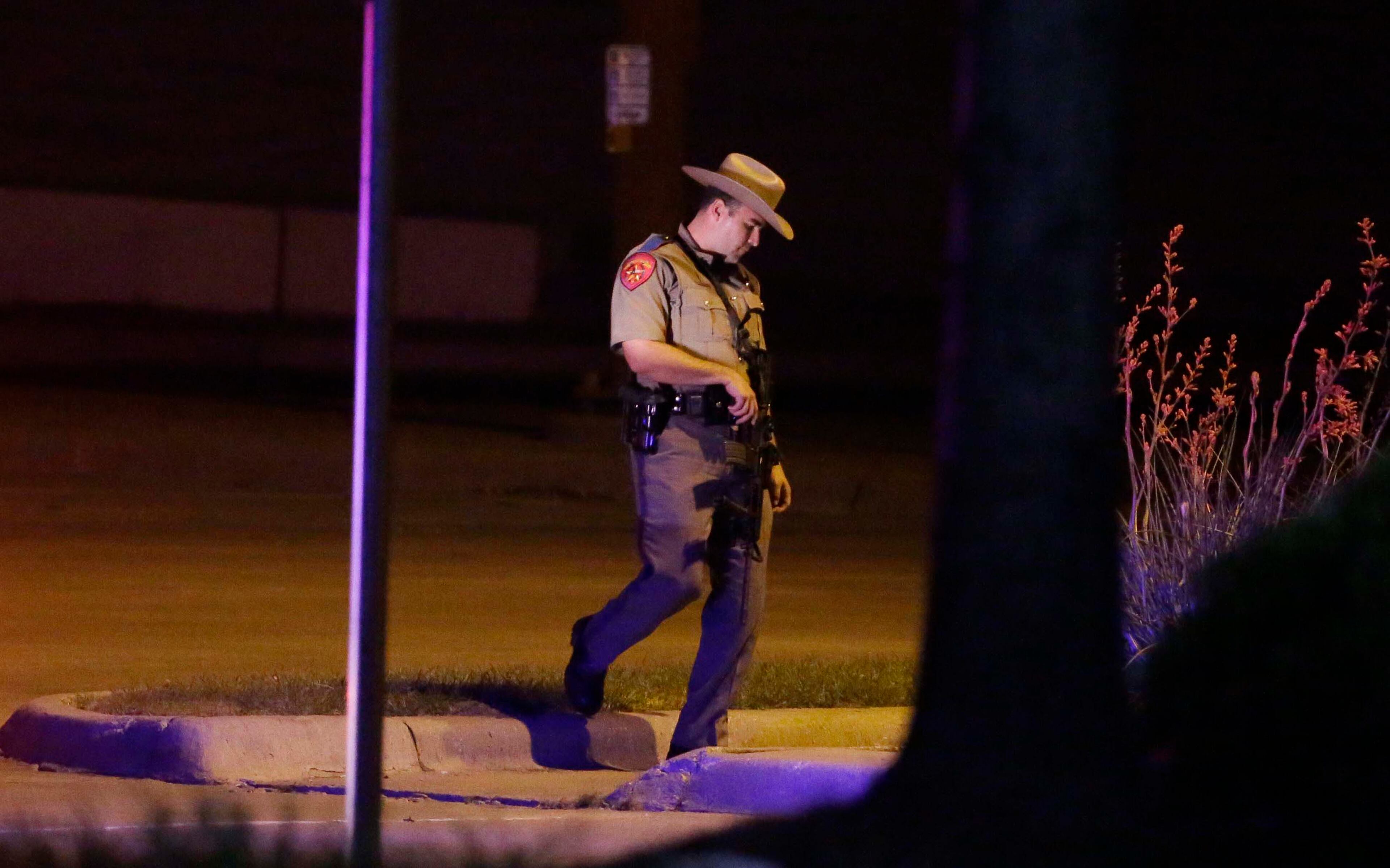 A Texas state trooper stands guard at a parking lot near the Curtis Culwell Center where a provocative contest for cartoon depictions of the Prophet Muhammad was held May 3, 2015, in Garland, Texas.