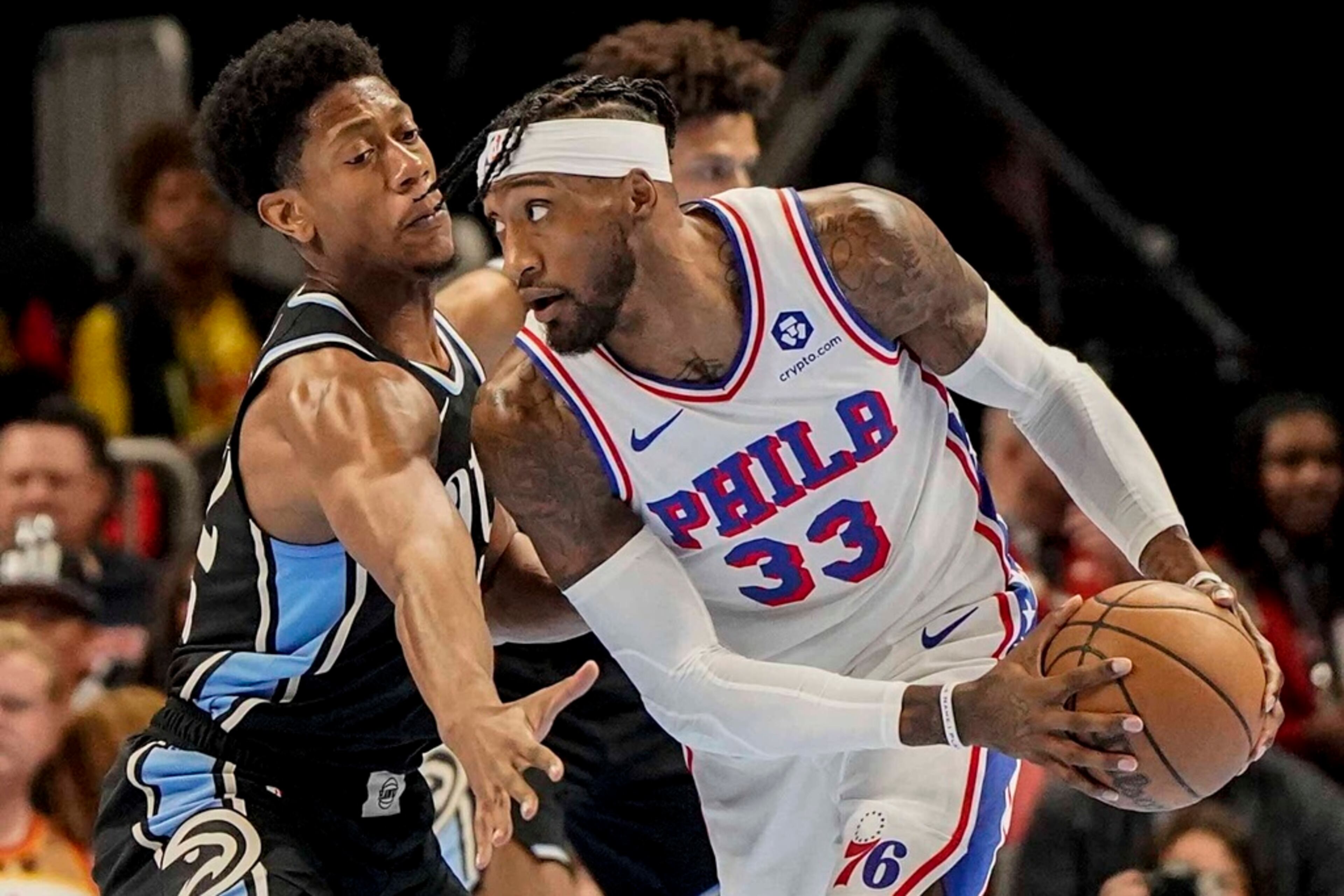 Philadelphia 76ers forward Robert Covington (33) drives against Atlanta Hawks forward De'Andre Hunter (12) during the first half of an In-Season Tournament NBA basketball game, Friday, Nov. 17, 2023, in Atlanta. (AP Photo/Mike Stewart)