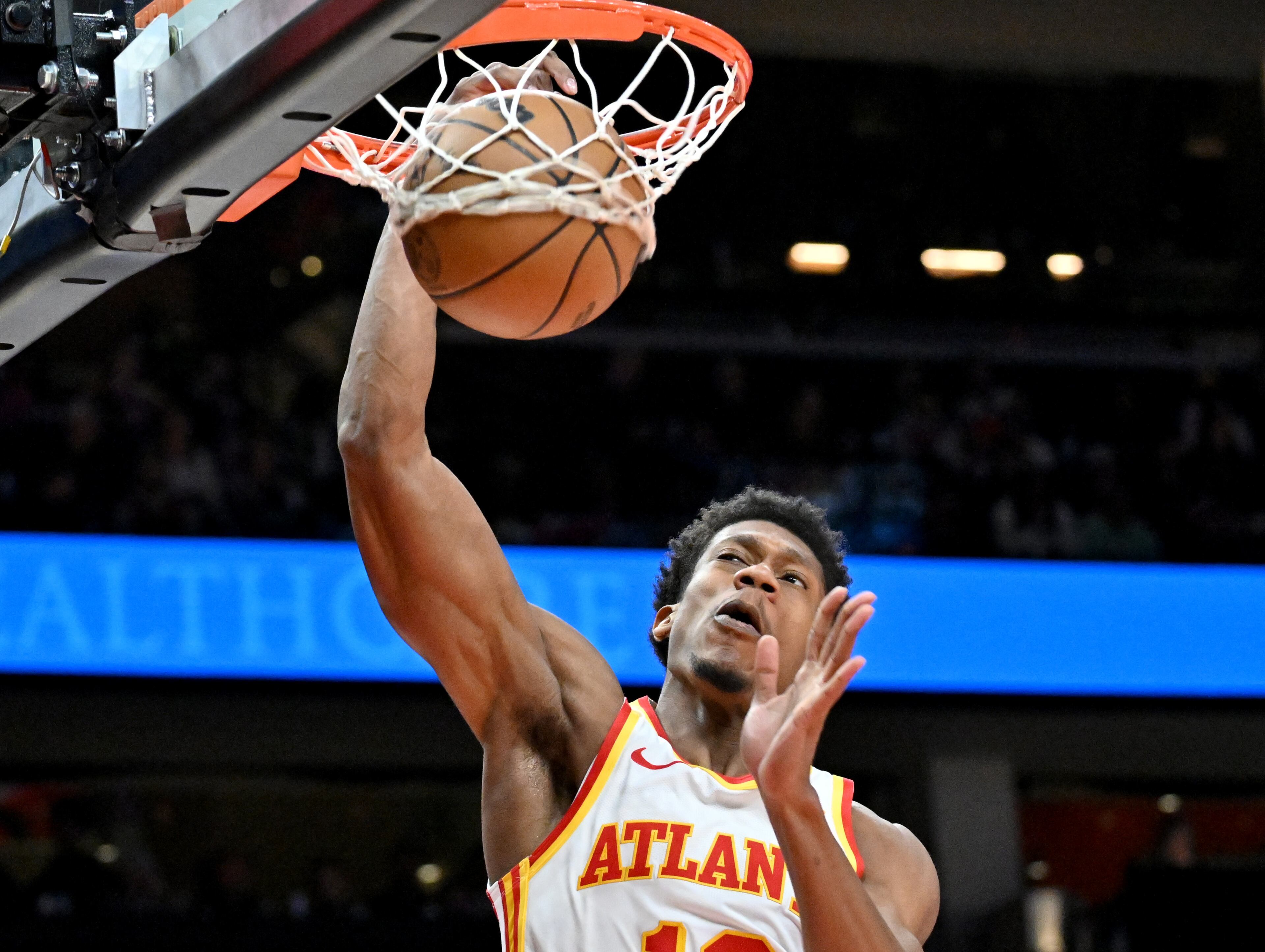 Atlanta Hawks forward De'Andre Hunter (12) dunks the ball against the Memphis Grizzlies during the second half in an NBA basketball game at State Farm Arena, Saturday, December 21, 2024, in Atlanta. Memphis Grizzlies won 128-112 over Atlanta Hawks. (Hyosub Shin / AJC)
