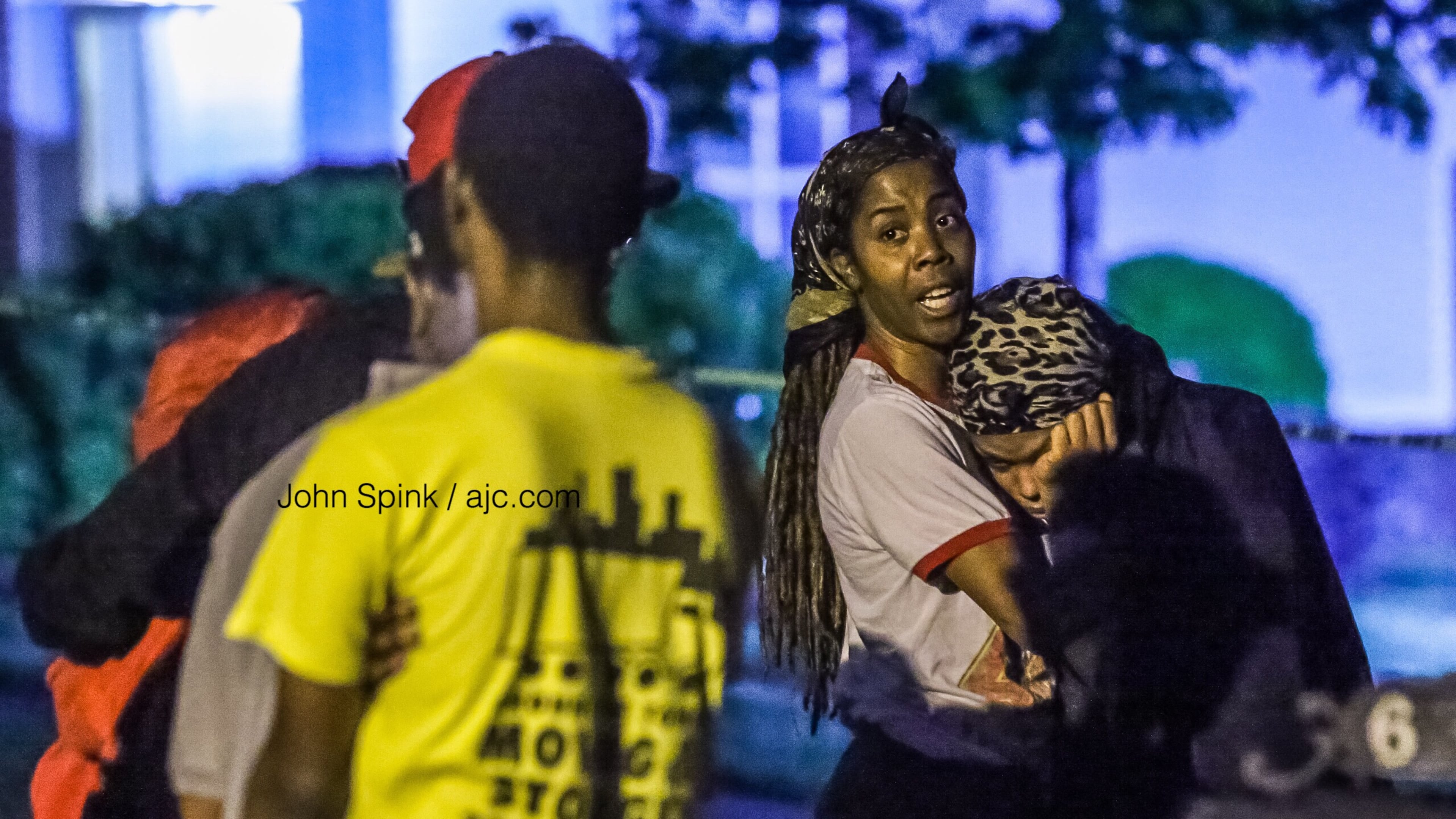 Family members and friends gather outside a home on Olmadison Place in South Fulton on Friday morning after a 21-year-old man was shot and killed.