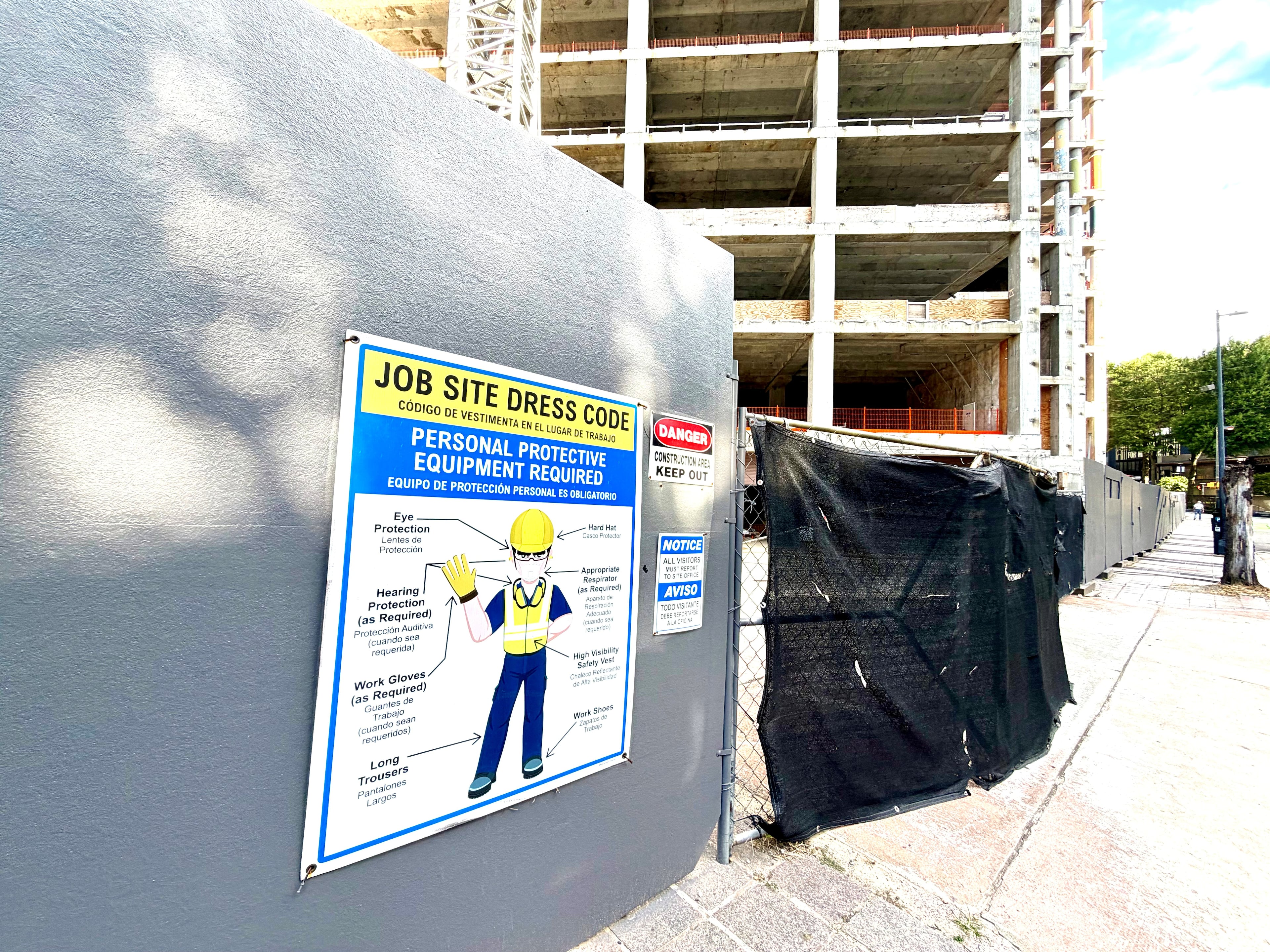 A poster showing required personal protective equipment is seen outside the Campanile building along Juniper Street in Midtown Atlanta on Thursday, Sept. 10, 2026. (J. Scott Trubey/AJC)