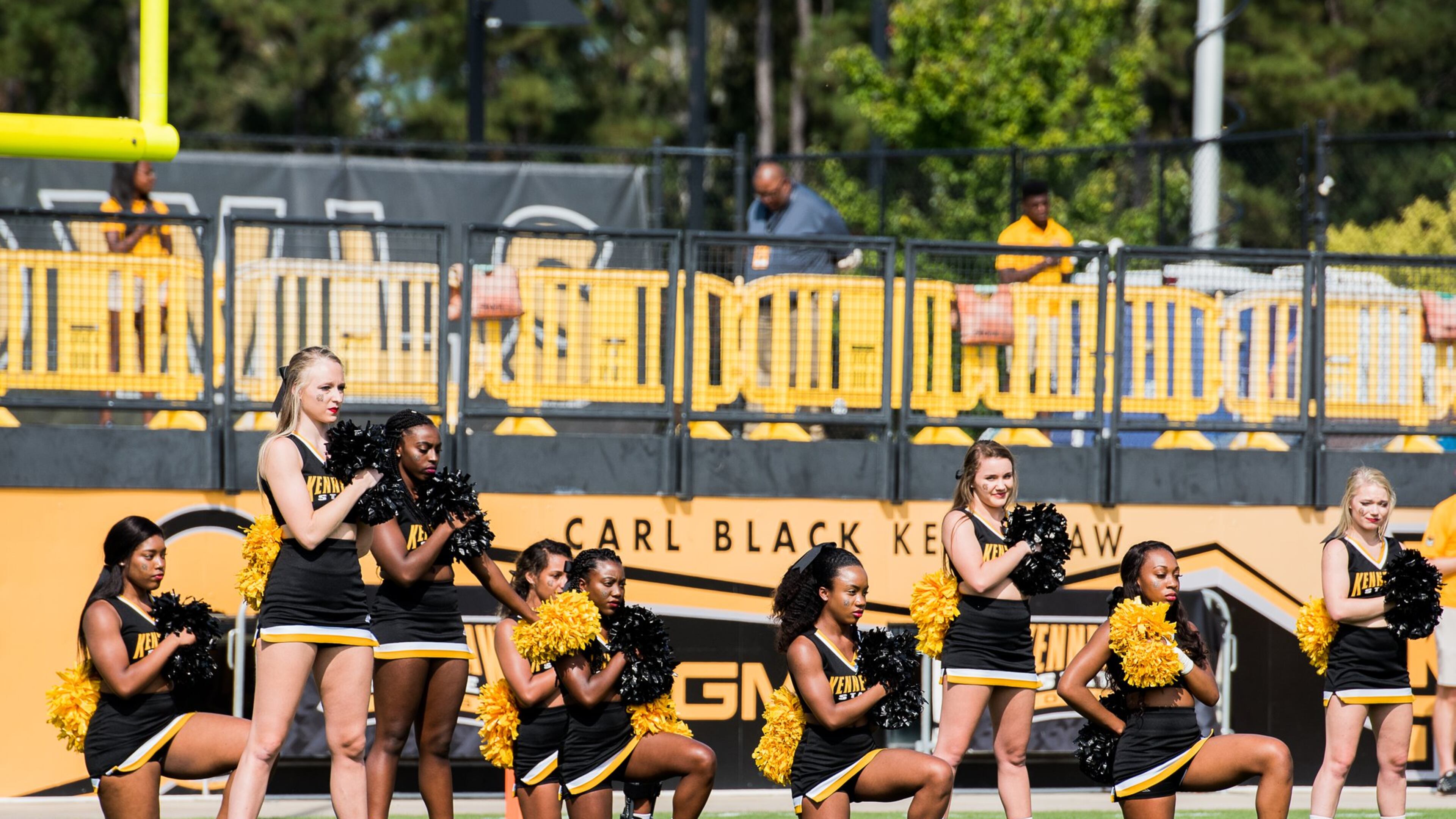 A handful of cheerleaders take a knee during the national anthem prior to the matchup between Kennesaw State and North Greenville on Saturday, Sept. 30, 2017. (Special to AJC/by Cory Hancock)
