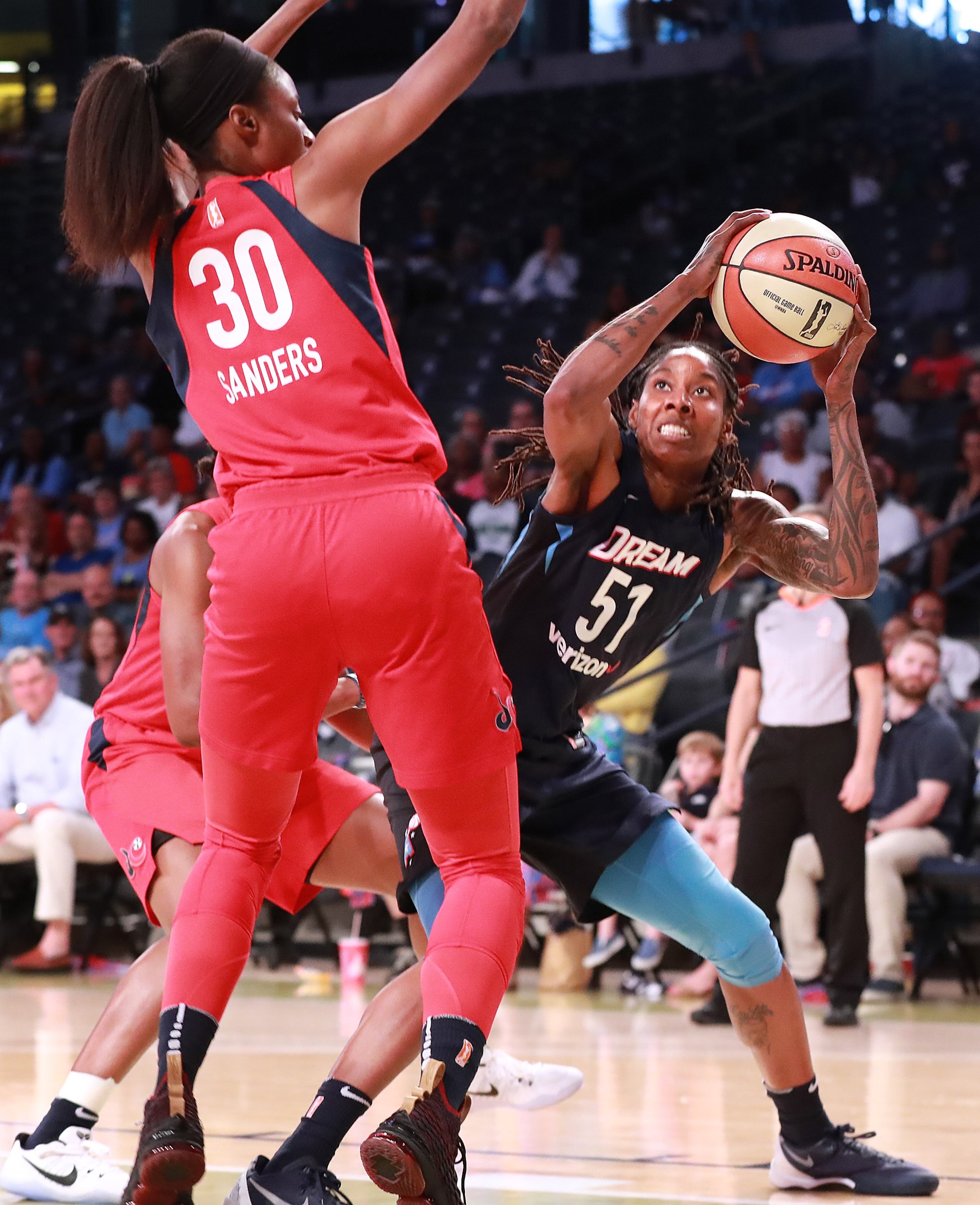 August 26, 2018 Atlanta: Atlanta Dream forward Jessica Breland looks to shoot around Washington Mystics defender LaToya Sanders during the first half in a WNBA semifinal playoff game on Sunday, August 26, 2018, in Atlanta. Curtis Compton/ccompton@ajc.com