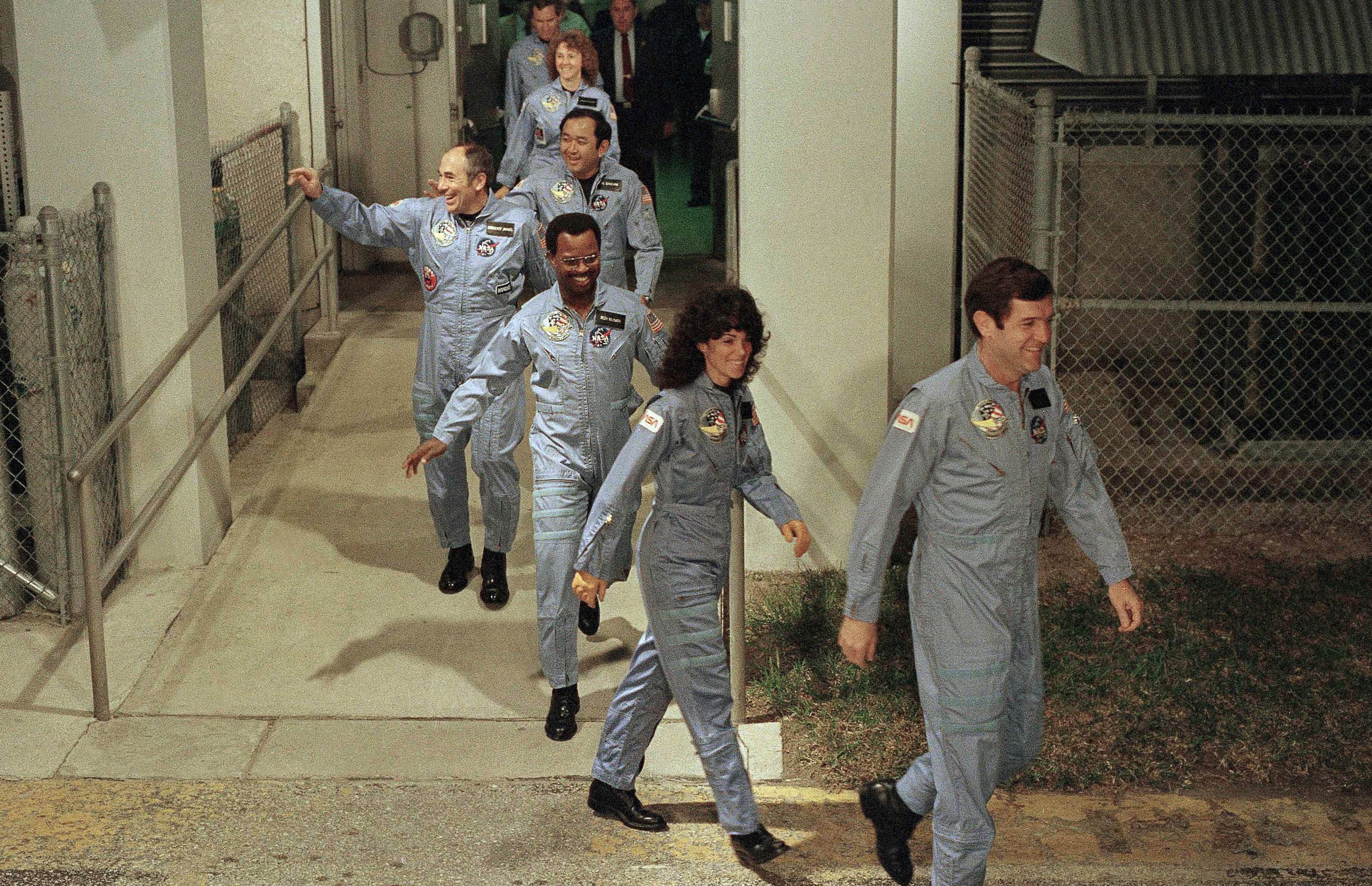 In this Jan. 27, 1986 file picture, the crew members of space shuttle Challenger flight 51-L, leave their quarters for the launch pad at Kennedy Space Center in Cape Canaveral, Fla. From foreground are commander Francis Scobee, Mission Spl. Judith Resnik, Mission Spl. Ronald McNair, Payload Spl. Gregory Jarvis, Mission Spl. Ellison Onizuka, teacher Christa McAuliffe and pilot Michael Smith. (AP Photo/Steve Helber)