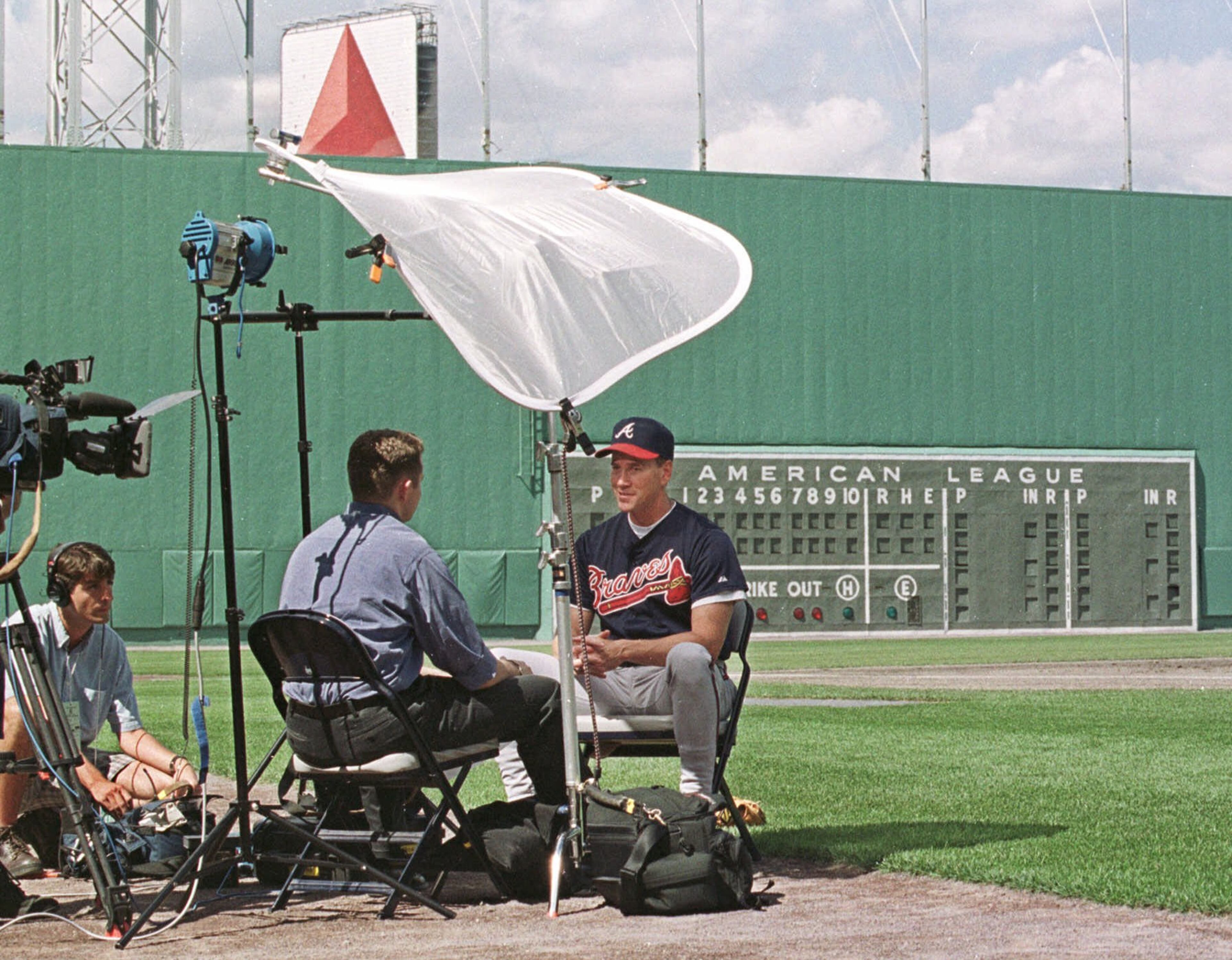 Atlanta Braves pitcher, and Massachusetts native, Tom Glavine, right, is interviewed by a television crew prior to the interleague game with the Boston Red Sox at Fenway Park in Boston, Saturday, July 8, 2000.