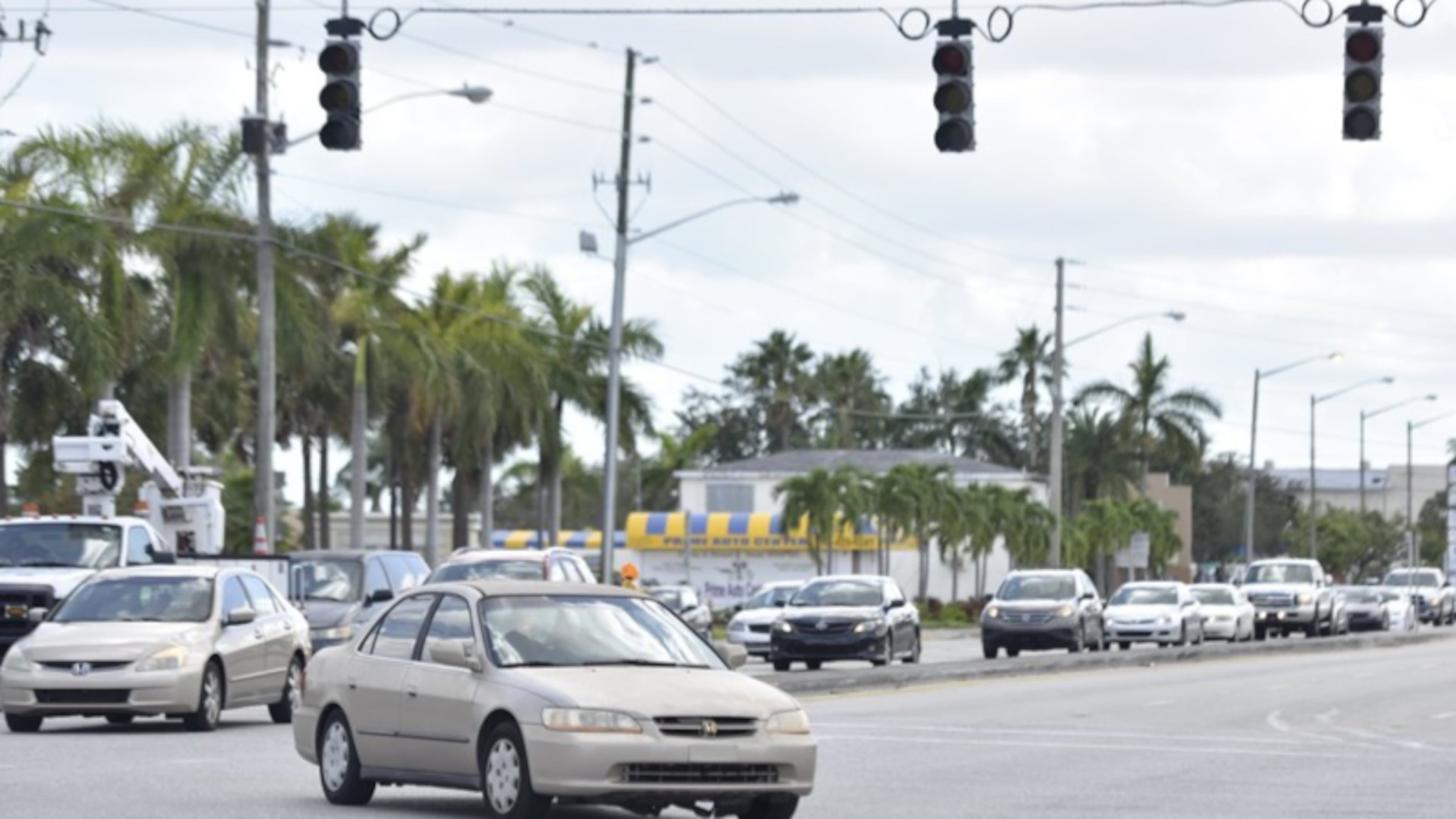 A car makes a left turn across the intersection of Forest Hill Boulevard and South Congress Avenue, which has no working traffic lights, in West Palm Beach, Florida, on Tuesday, September 12, 2017.