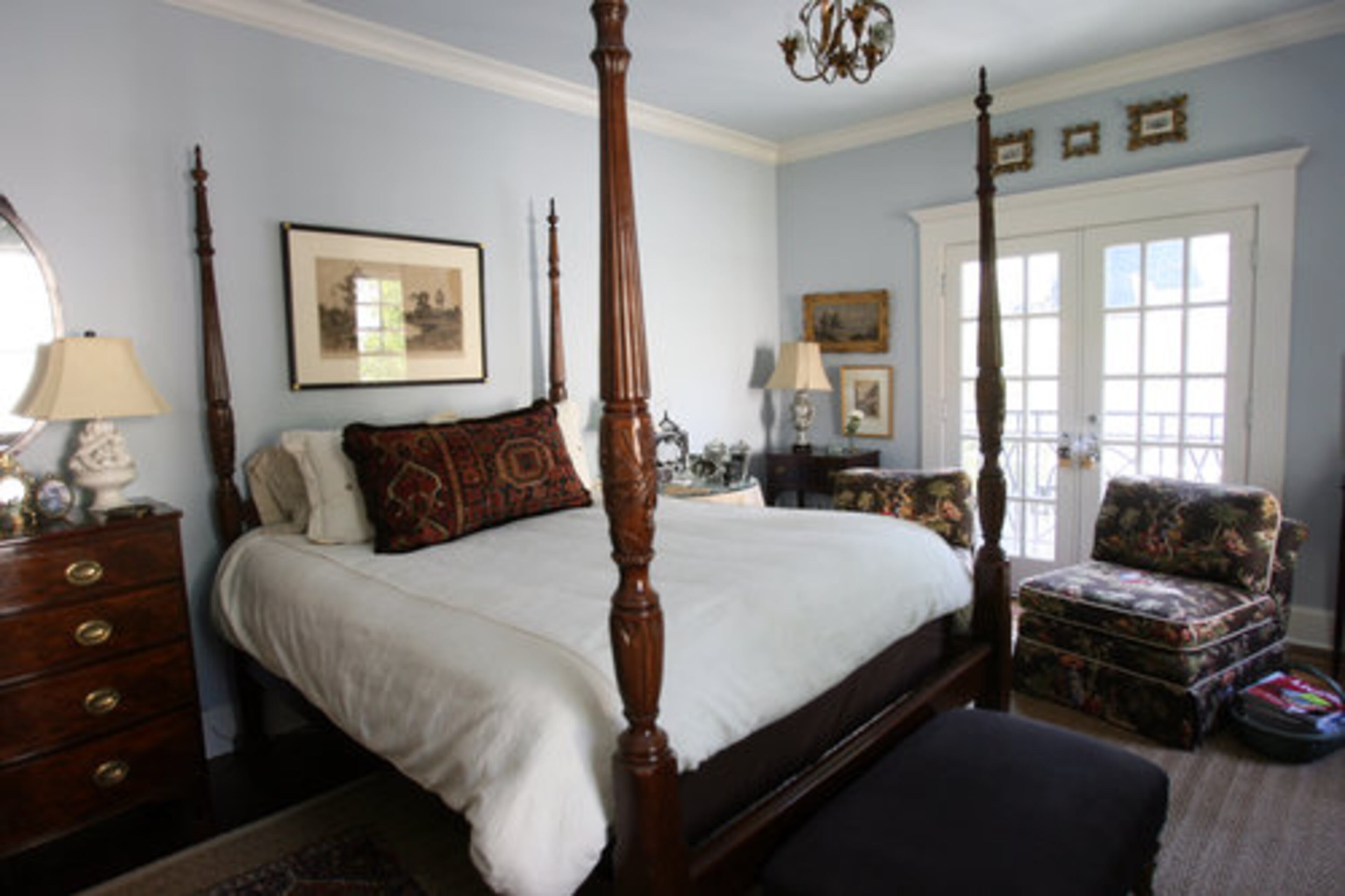 The guest bedroom offers views out to the backyard.
