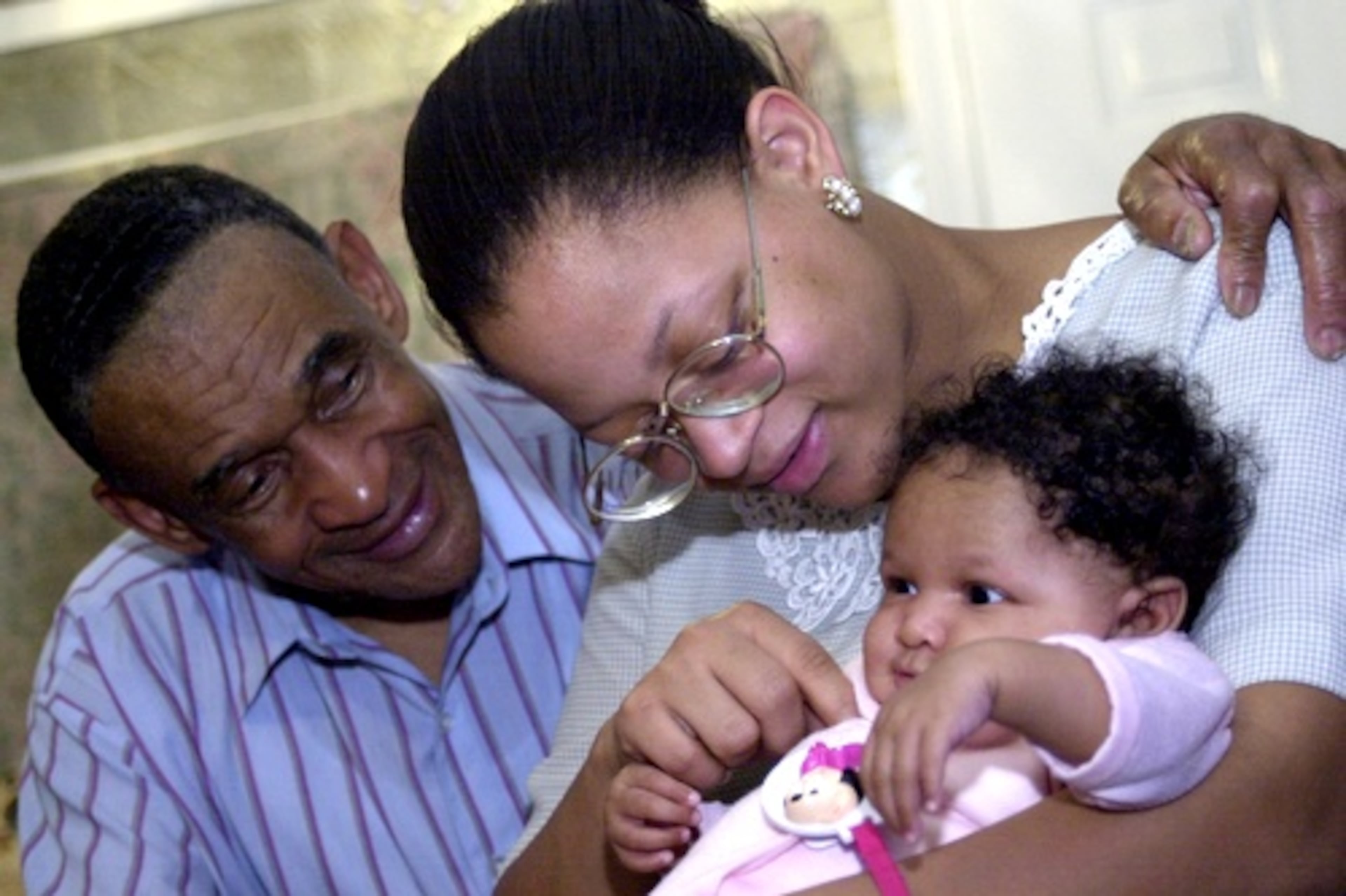 In the meantime, the Rev. Allen became a new father again. His wife and congregant, Trina Allen, was 25 years old in 2001 and gave birth to Amber Rose, 2 months old in the picture, at their home. (BITA HONARVAR/BHONARVAR@AJC.COM)