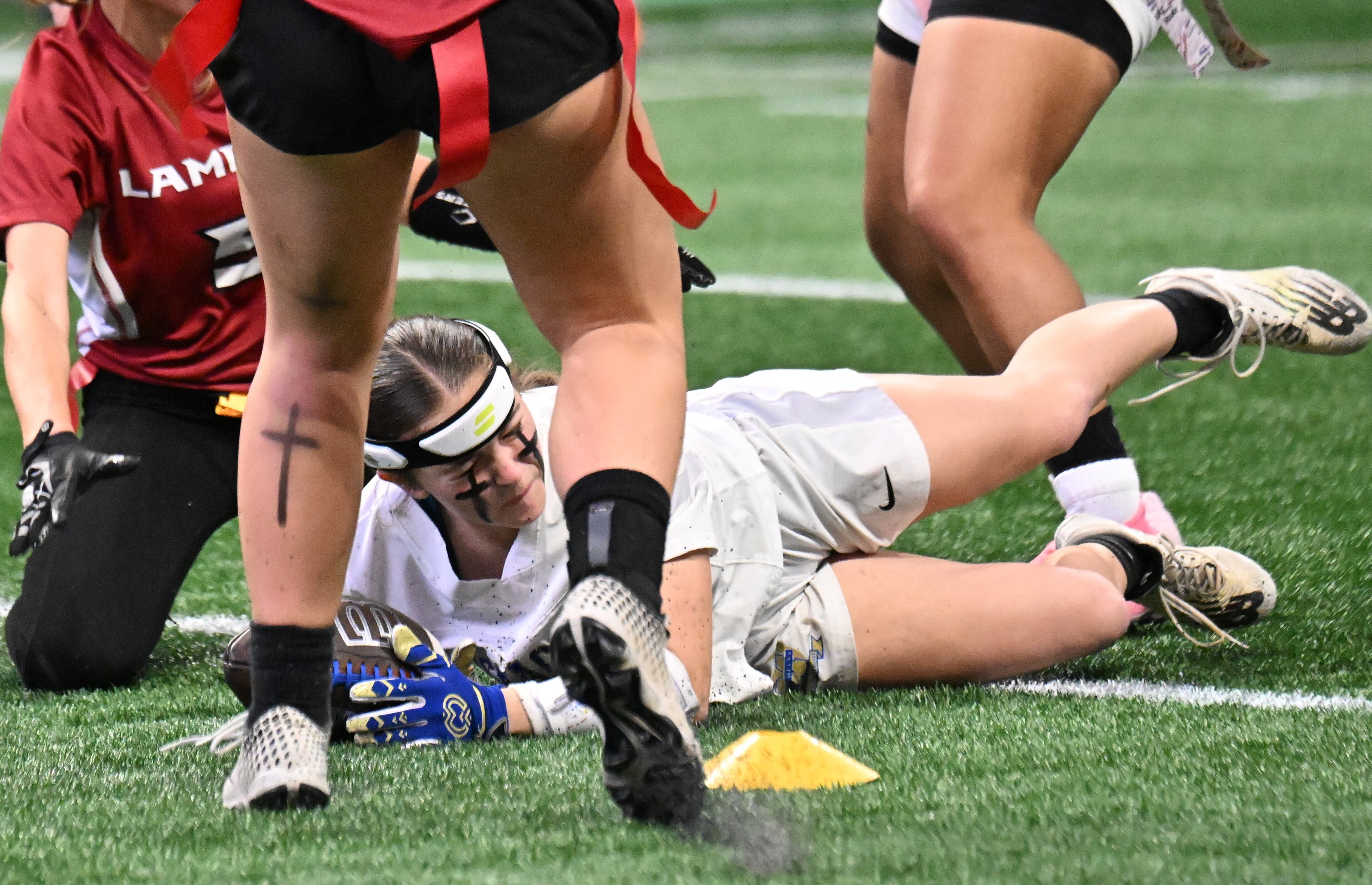 McEachern’s Tami Chatwood (1) dives into the end zone for a touchdown during the second half in GHSA Division 4 Flag Football State Championship game at Mercedes-Benz Stadium, Wednesday, December 18, 2024, in Atlanta. McEachern won 26-6 over Lambert. (Hyosub Shin / AJC)