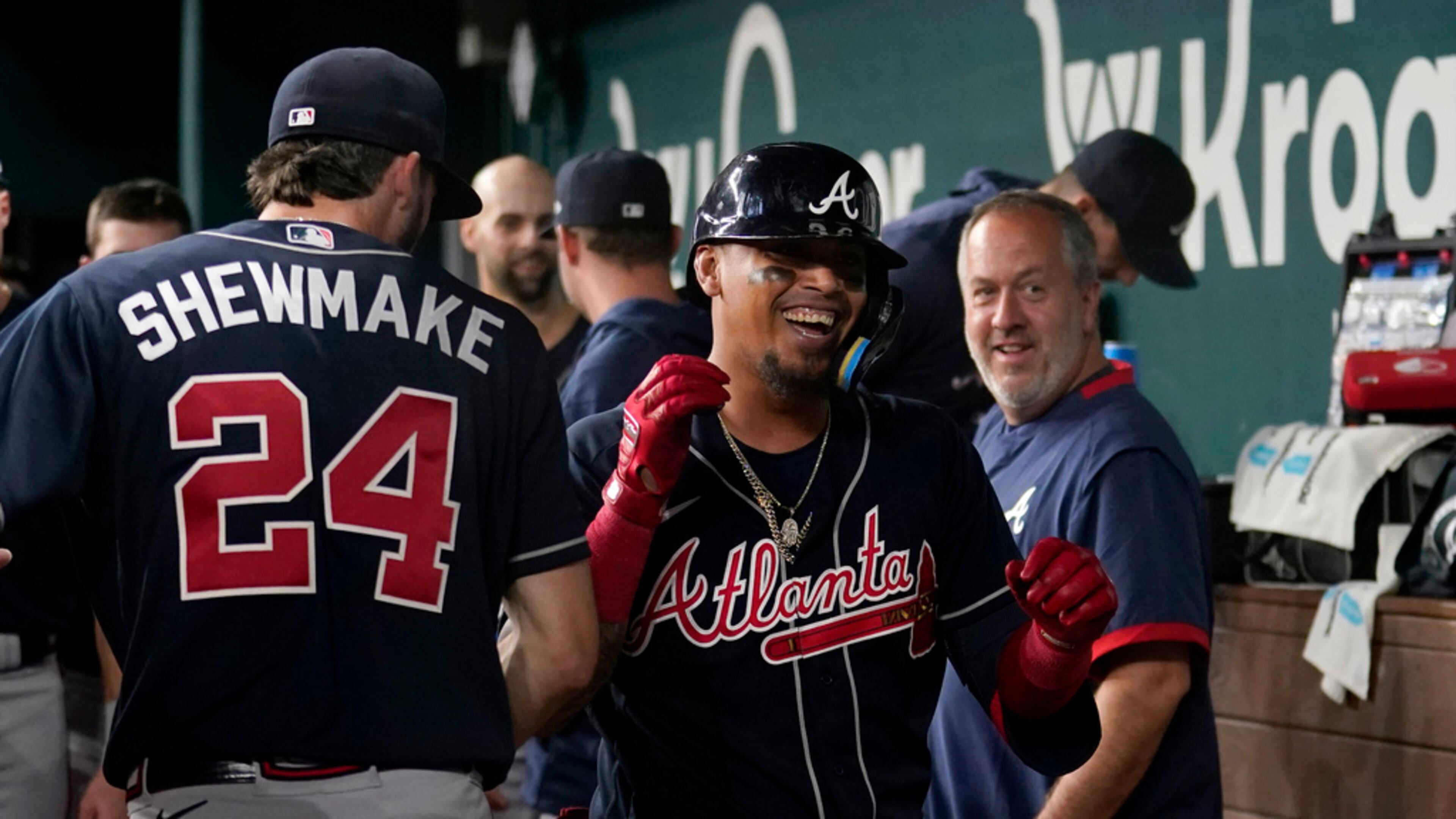 Atlanta Braves' Braden Shewmake (24) and Orlando Arcia, center, celebrate in the dugout after Arcia hit a solo home run in the ninth inning of the team's baseball game against the Texas Rangers, Wednesday, May 17, 2023, in Arlington, Texas. (AP Photo/Tony Gutierrez)