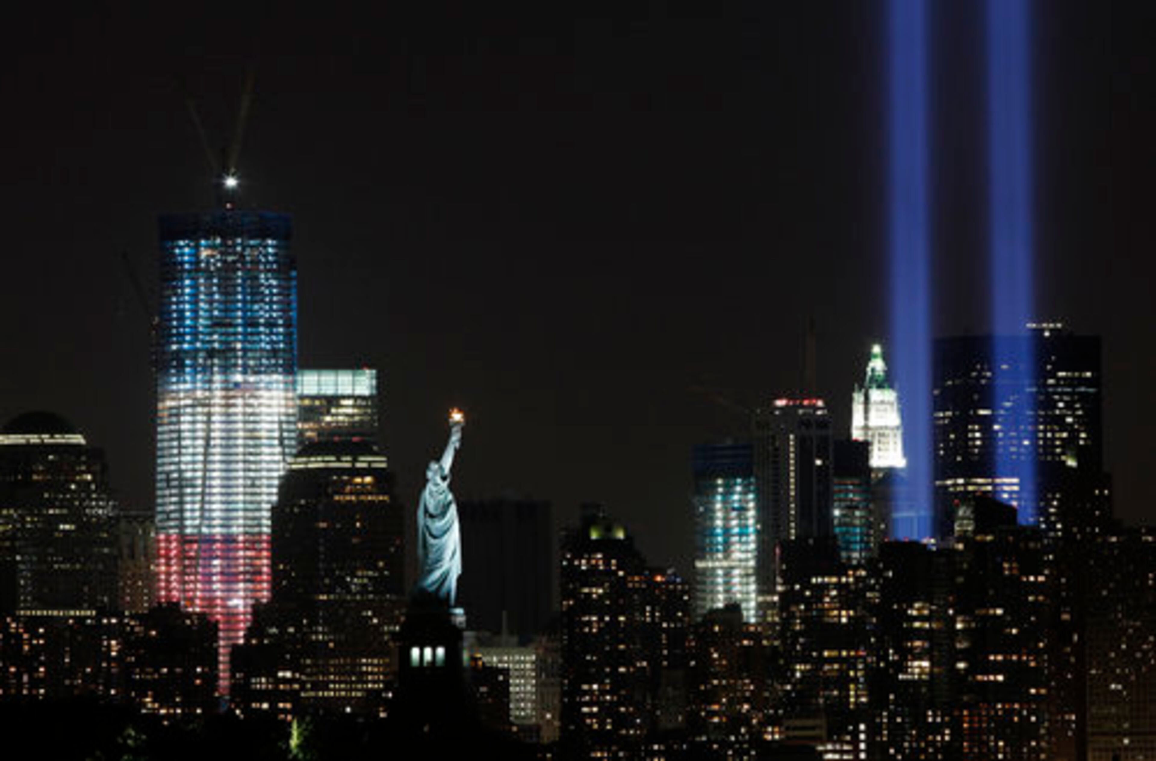FILE -In this Sept. 10, 2011 file photo, the "Tribute in Light" shines above lower Manhattan, the Statue of Liberty, and One World Trade Center, left, in New York. 2011 marks the 10th anniversary of the Sept. 11, 2001 attacks on the United States.