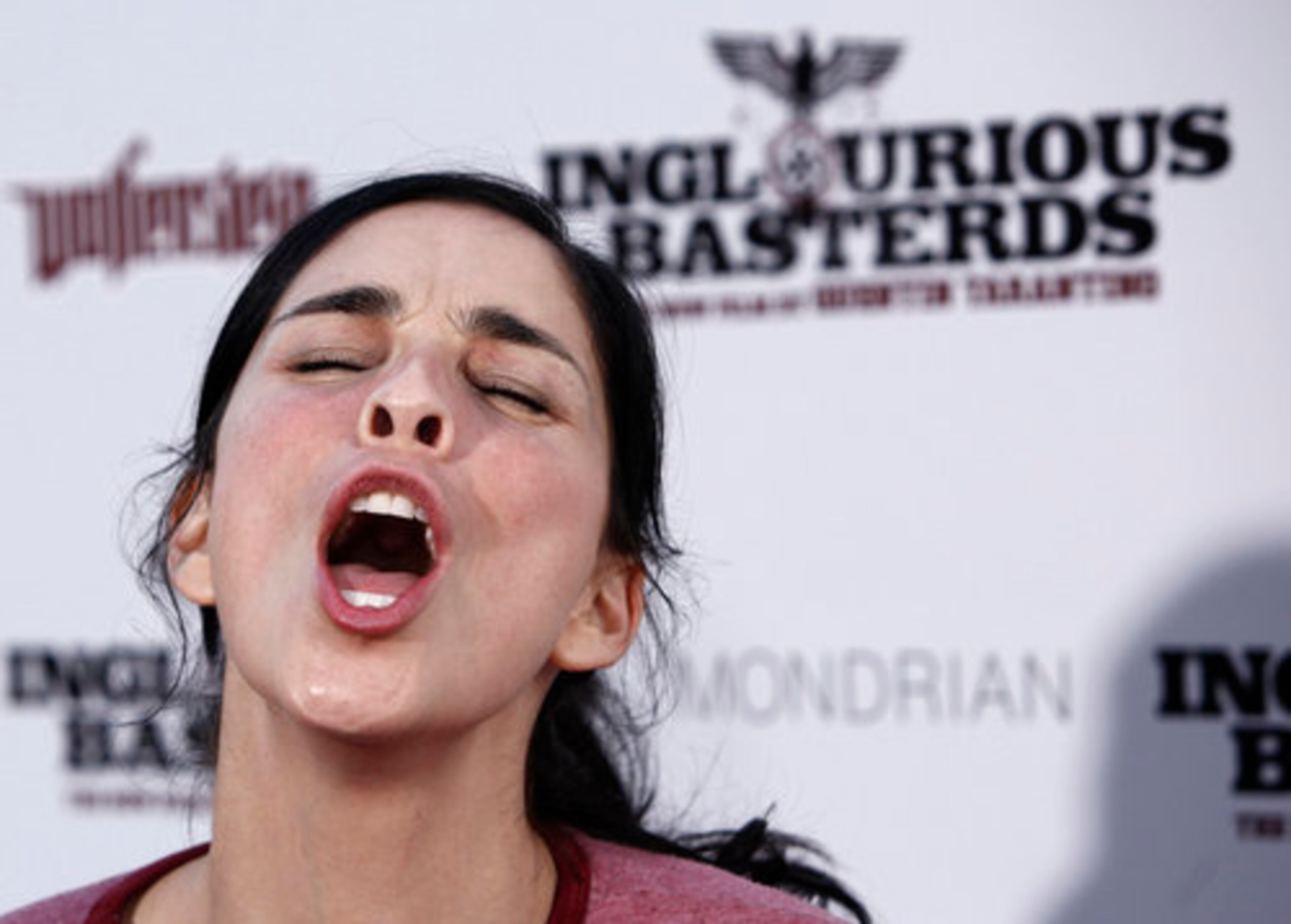 SARAH SILVERMAN shows her trademark restraint. (She's obviously that person who everybody hates to have in family photos, because she makes dumb faces and refuses to just smile.)