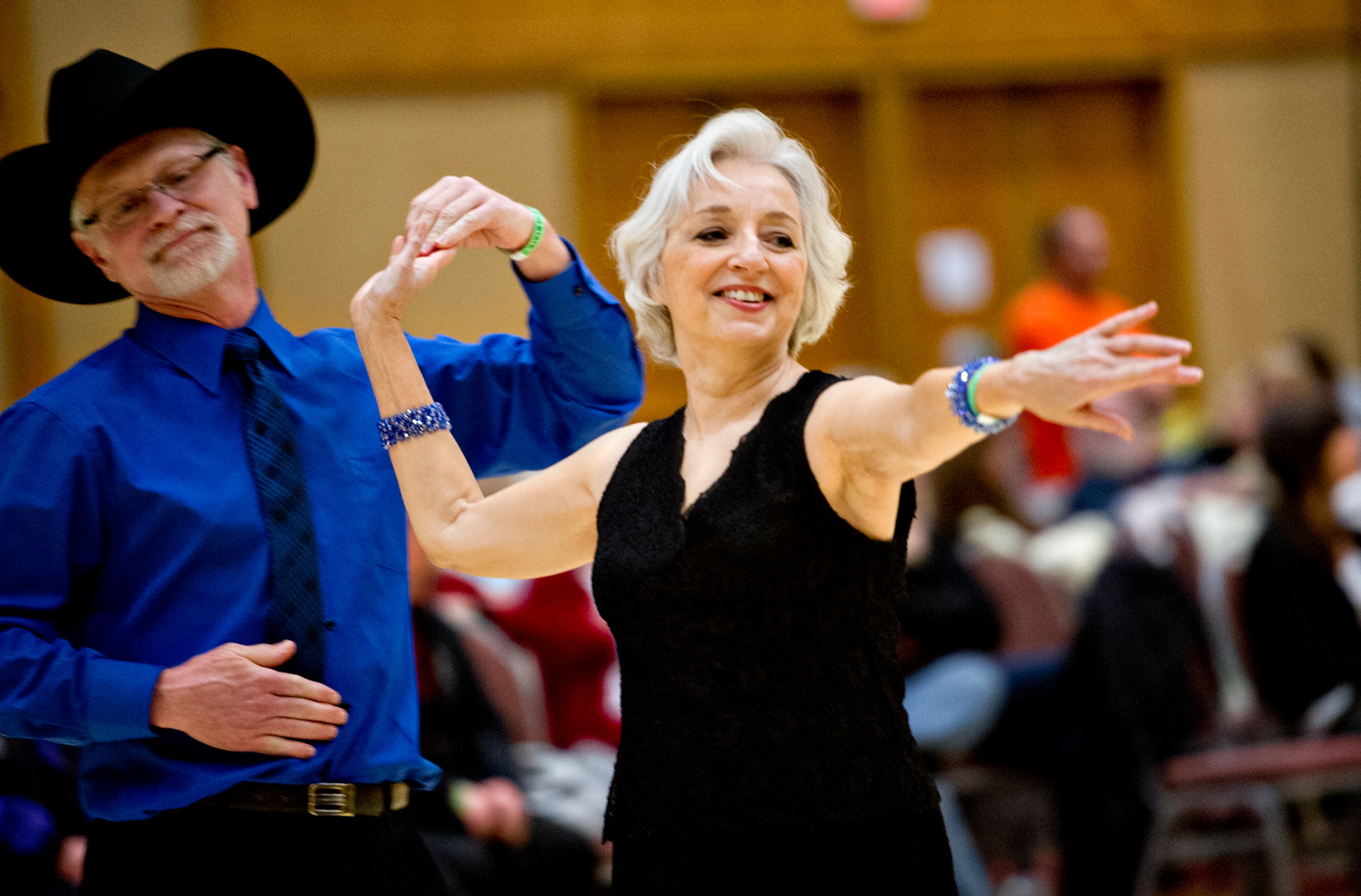 Linda Hunt (right) dances the triple two with her partner Wayne Tipton during the Peach State Dance Festival at the Crown Plaza Ravinia hotel in Atlanta on Saturday, March 22, 2014. Approximately 1,000 country, swing and line dancers filled the hotel in Dunwoody for a weekend of instruction, competition, social dancing, and dance performances. The festival is in its 24th year and is the largest of its kind in the southeast.