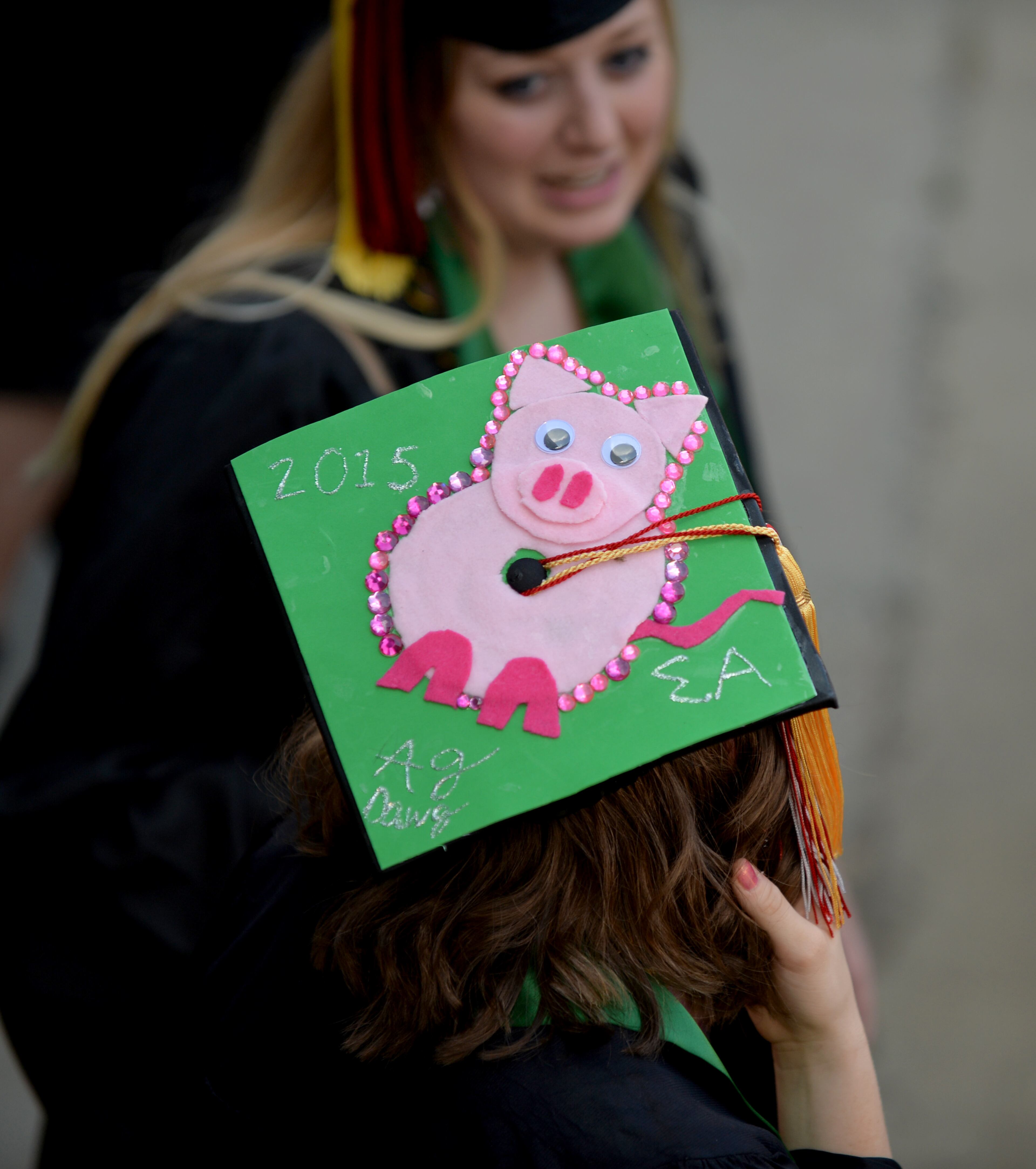 Many students personalize their mortarboards, a look at some of the eye-catchers. University of Georgia undergraduate commencement at Sanford Stadium Friday May 8, 2015. BRANT SANDERLIN/BSANDERLIN@AJC.COM