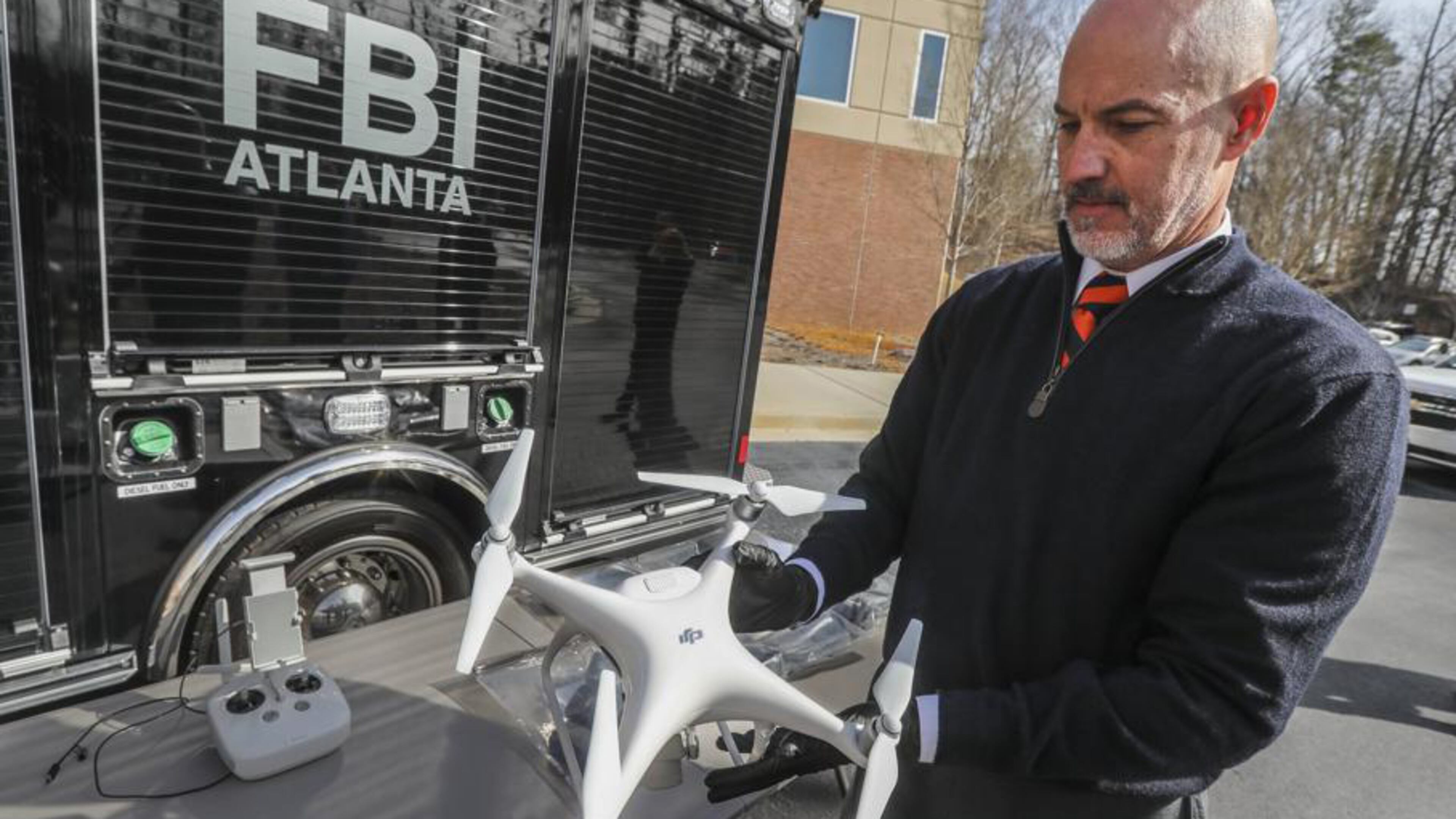 FBI Special Agent John Cronier with one of the six captured drones on Friday, Feb. 1, 2019, at the FBI Field Office in Atlanta.