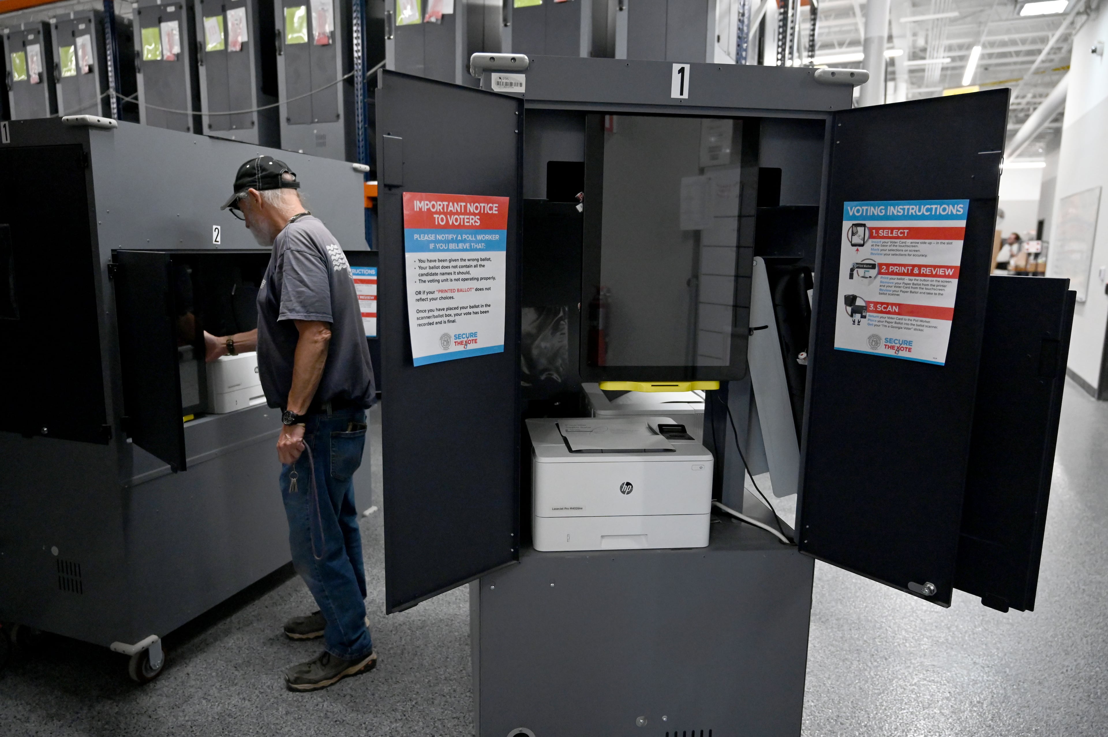 Election workers set up voting hubs at the Cobb County Elections and Registration building on Tuesday, Sept. 22, 2026, in Marietta. Voters should bring their Georgia driver’s license, passport or a voter ID card with them to the polls. (Hyosub Shin/AJC)