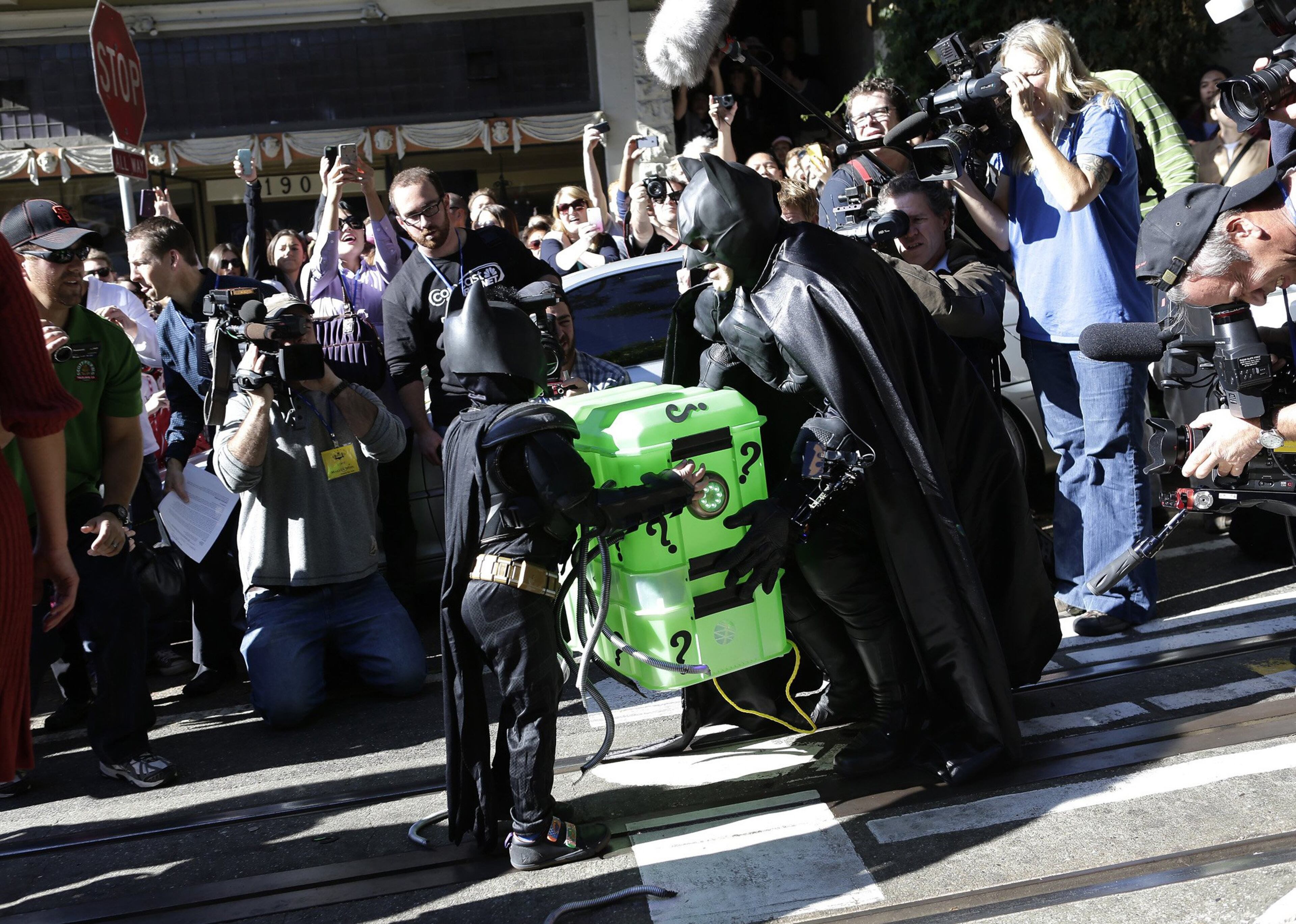 Miles Scott, 5, the Batkid, helps Batman move an "explosive device" in San Francisco on Friday, Nov. 15, 2013. Miles is a leukemia survivor from Tulelake in Siskiyou County, Calif. After battling leukemia since he was a year old, Miles is now in remission. One of his heroes is Batman, so to celebrate the end of his treatment, the Make-A-Wish Greater Bay Area granted his wish to become Batkid for a day.