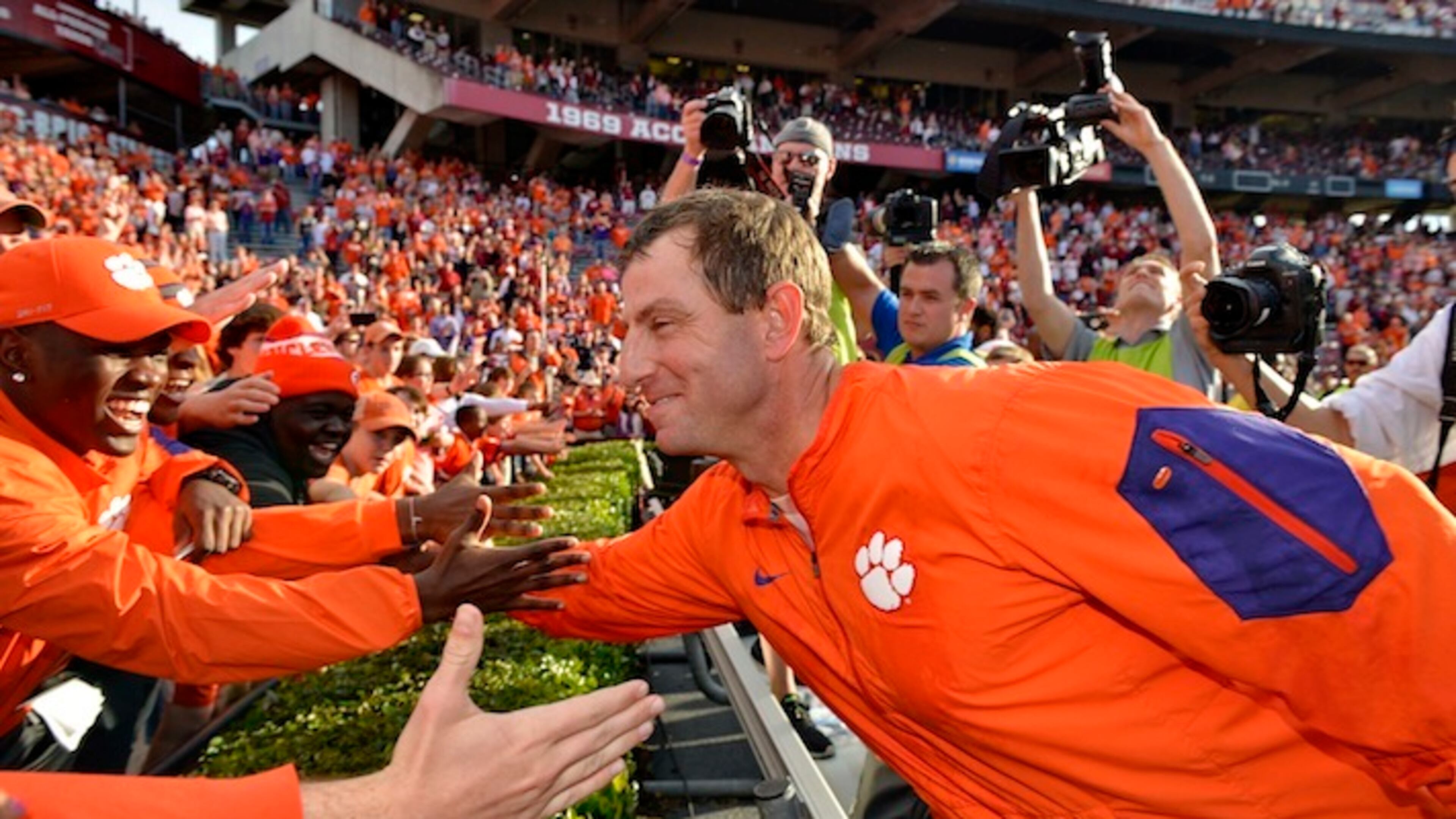 Clemson head coach Dabo Swinney celebrates with the fans after an NCAA college football game against South Carolina Saturday, Nov. 28, 2015, in Columbia, S.C. Clemson won 37-32. (AP Photo/Richard Shiro)