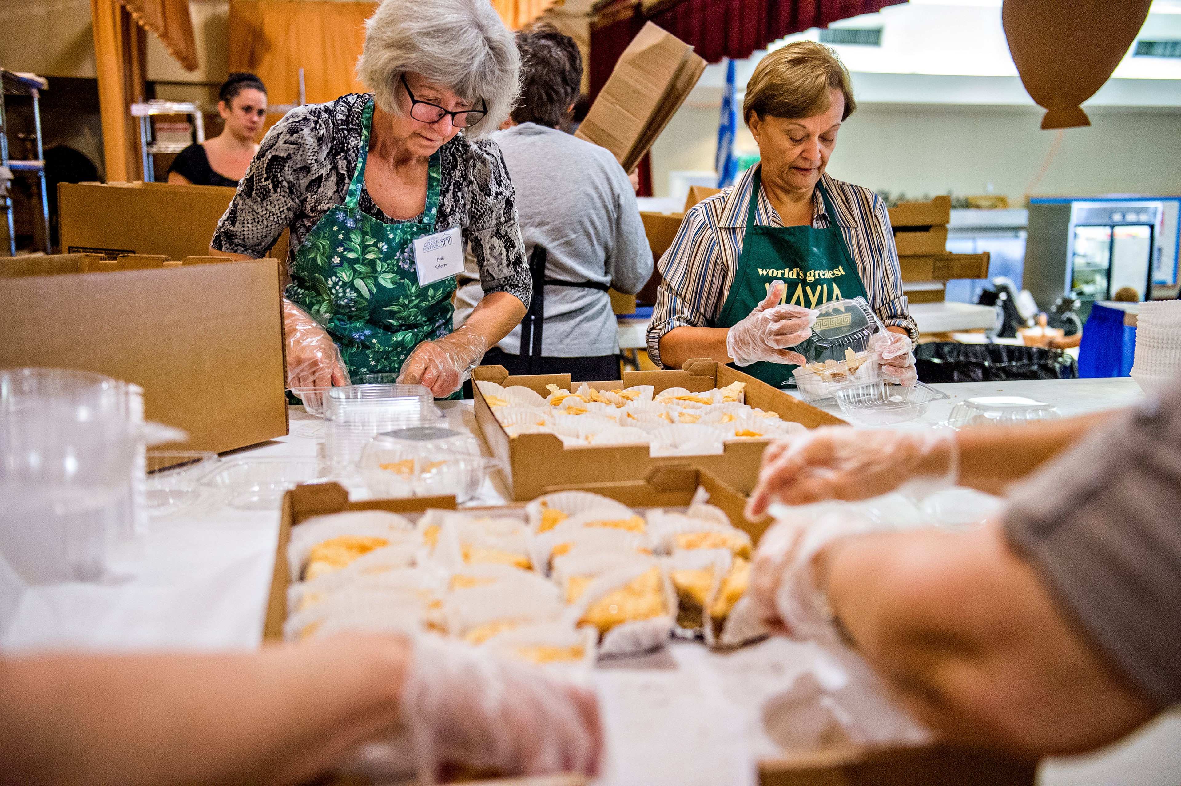 Kelli Holevas (left) and Amy Lekos fill pastry orders as they stuff containers with baklava during the Atlanta Greek Festival at the Greek Orthodox Cathedral of Annunciation on Saturday, September 26, 2015. The weekend long festival features everything Greek from food, shopping, performances, live music and tours of the church. JONATHAN PHILLIPS / SPECIAL
