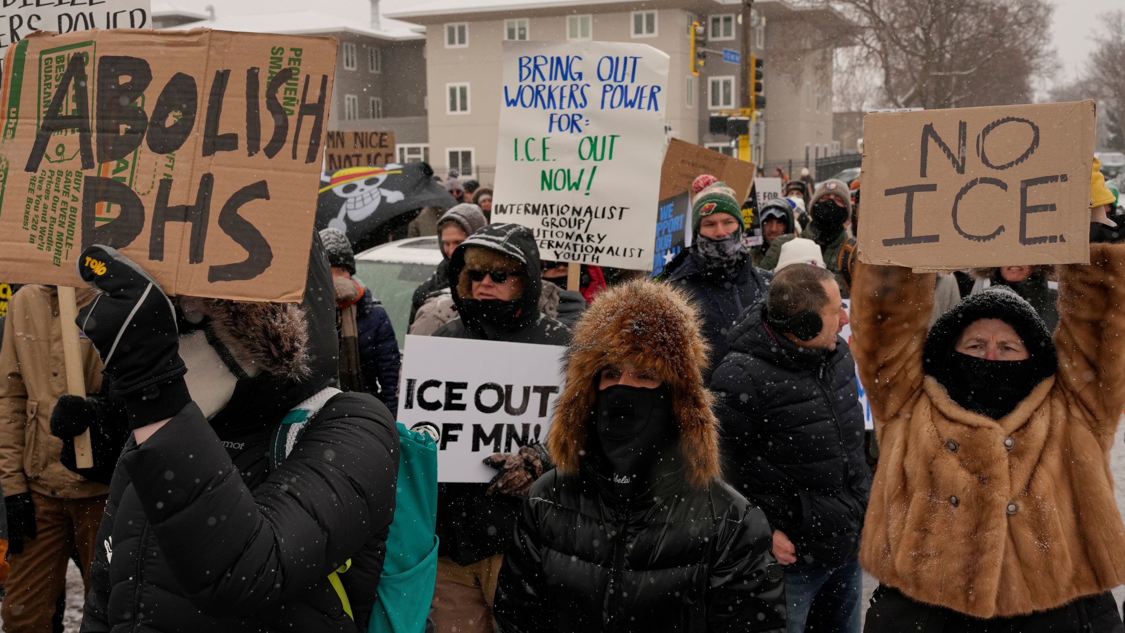 People gather near the post office during a protest, Sunday, Jan. 18, 2026, in Minneapolis. (AP Photo/Yuki Iwamura)