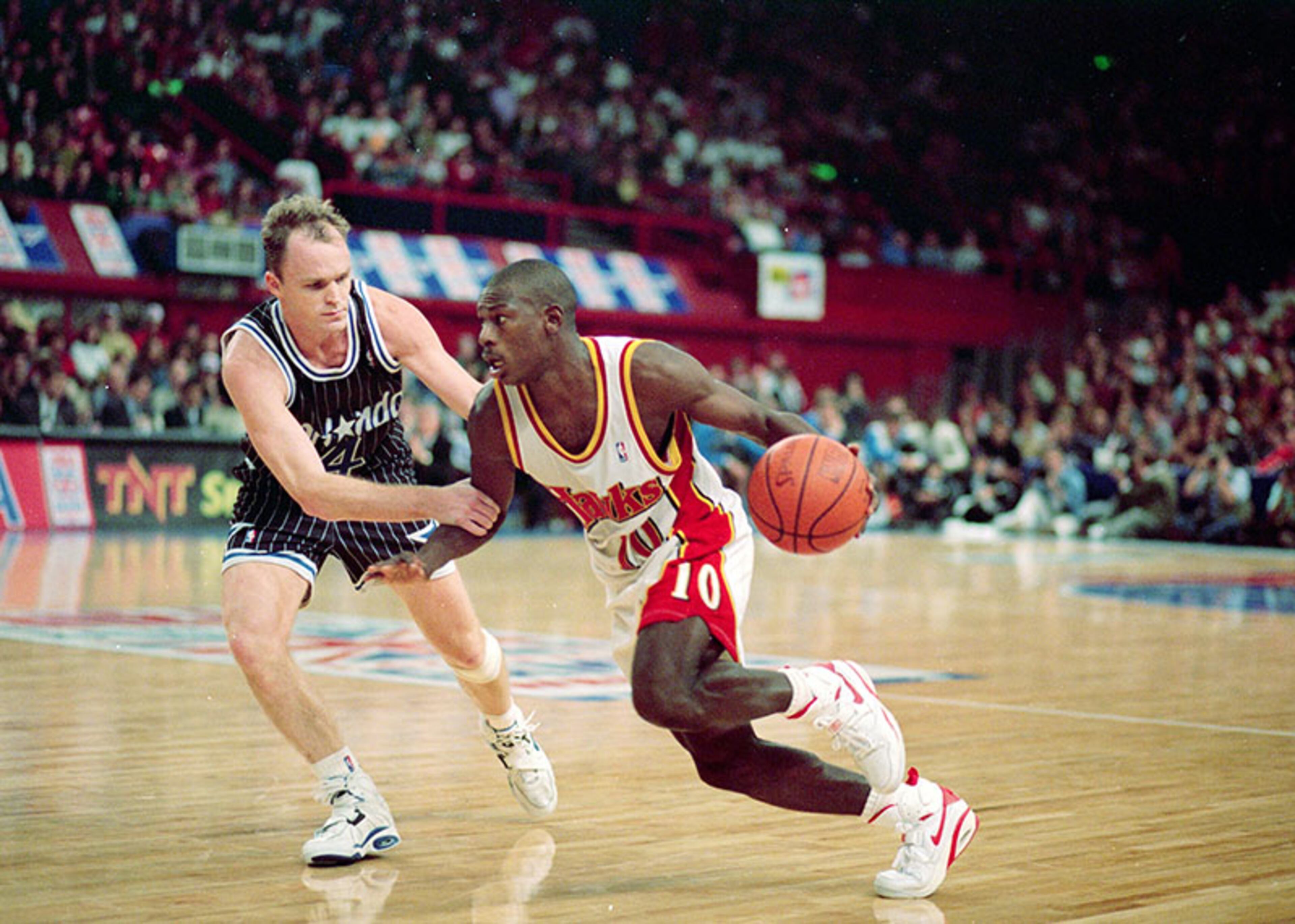 Oct. 31, 1993: Hawks guard Mookie Blaylock moves with the ball around the Magic's Scott Shiles. The Hawks built a 30-point lead, then withstood the Magic's second-half run for a 113-101 victory in the last of two preseason games against the Magic at London's Wembley Stadium.