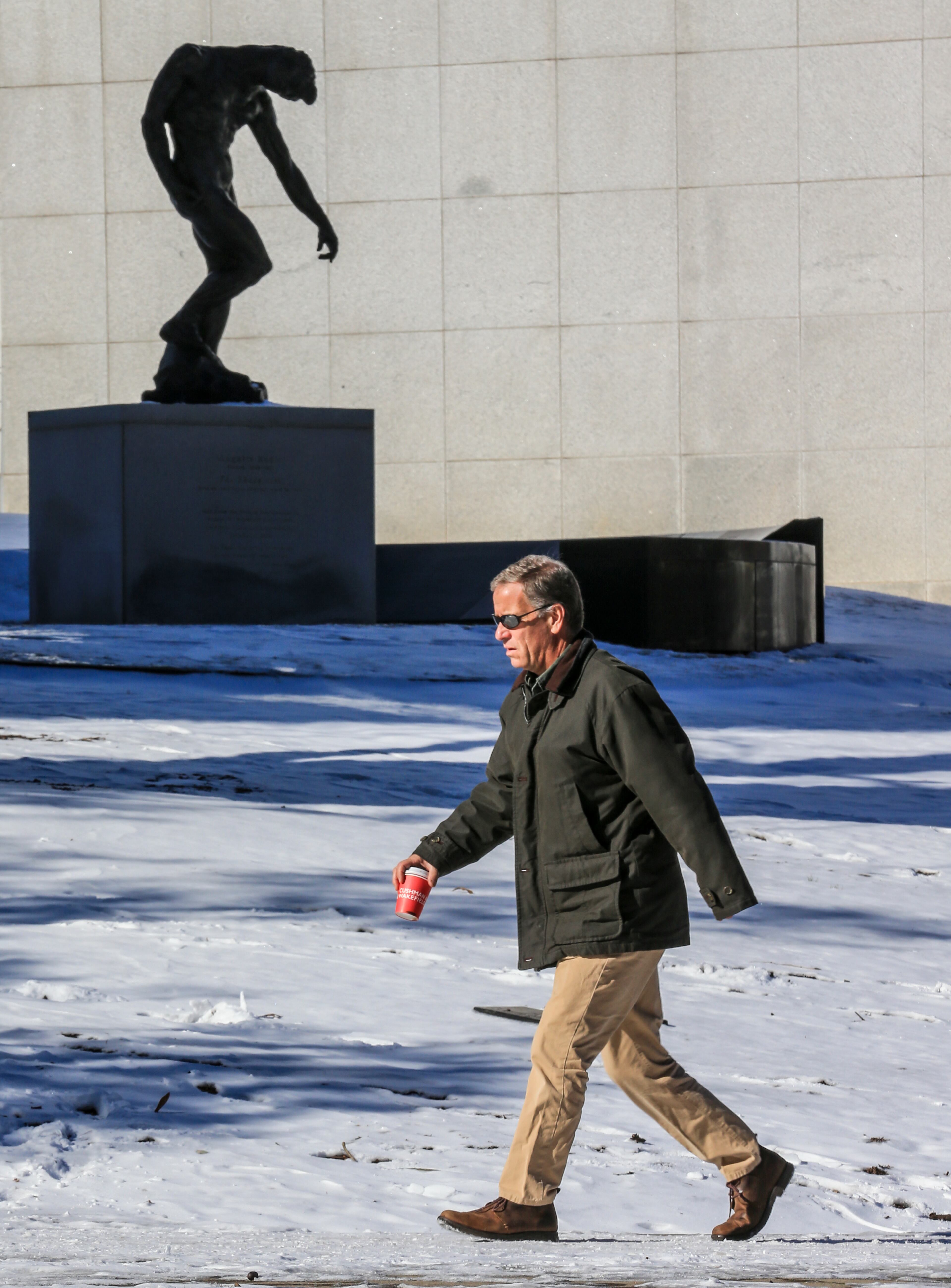 “The Shade” by Auguste Rodin looks out over a snowy High Museum lawn and Peachtree Street last month. JOHN SPINK/JSPINK@AJC.COM