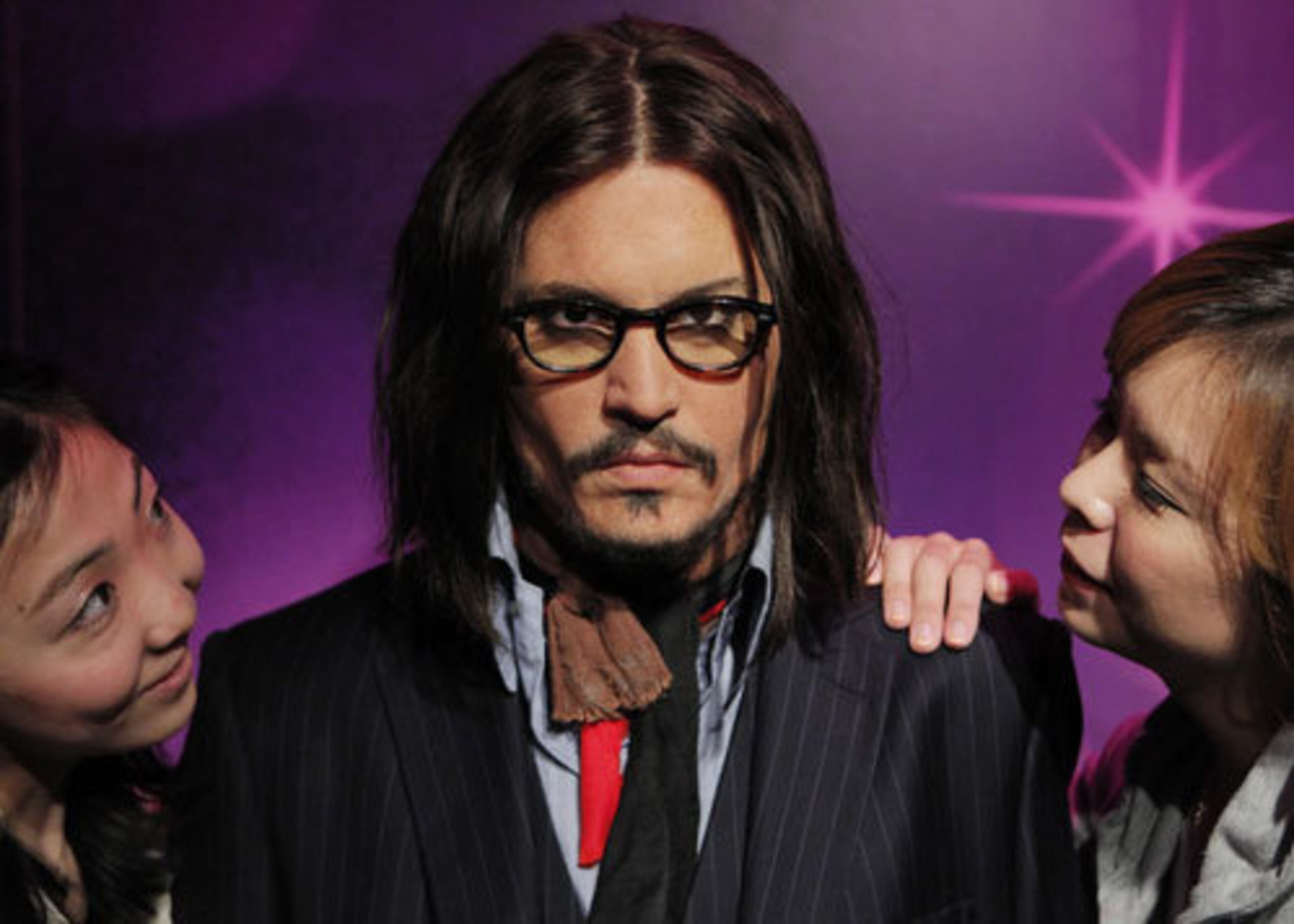 Models inspect the handiwork on the Johnny Depp wax figure.