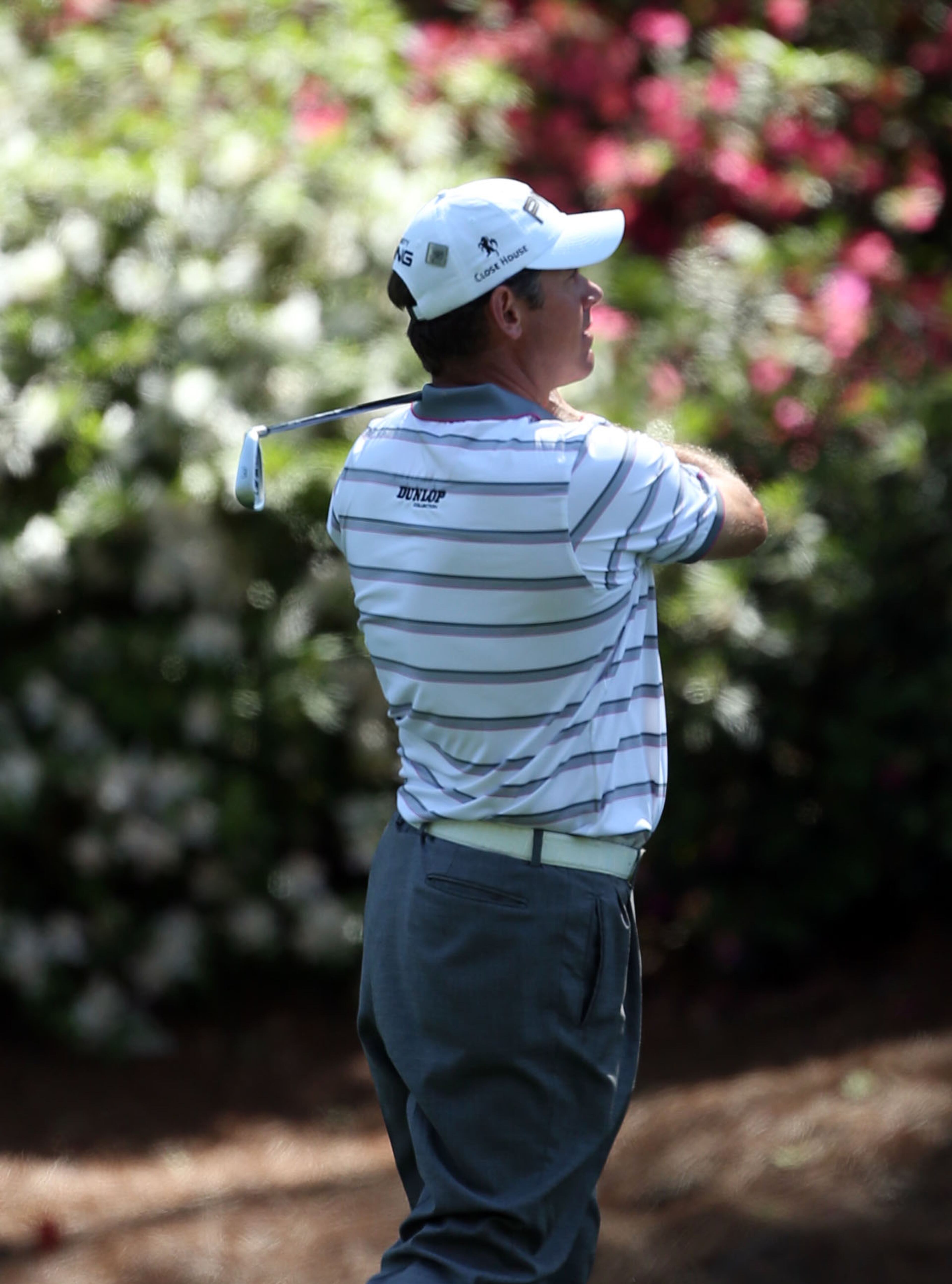 Lee Westwood hits in front of the azaleas on #13 during the second round in the Masters Tournament on Friday April 12 2013. JASON GETZ / JGETZ@AJC.COM