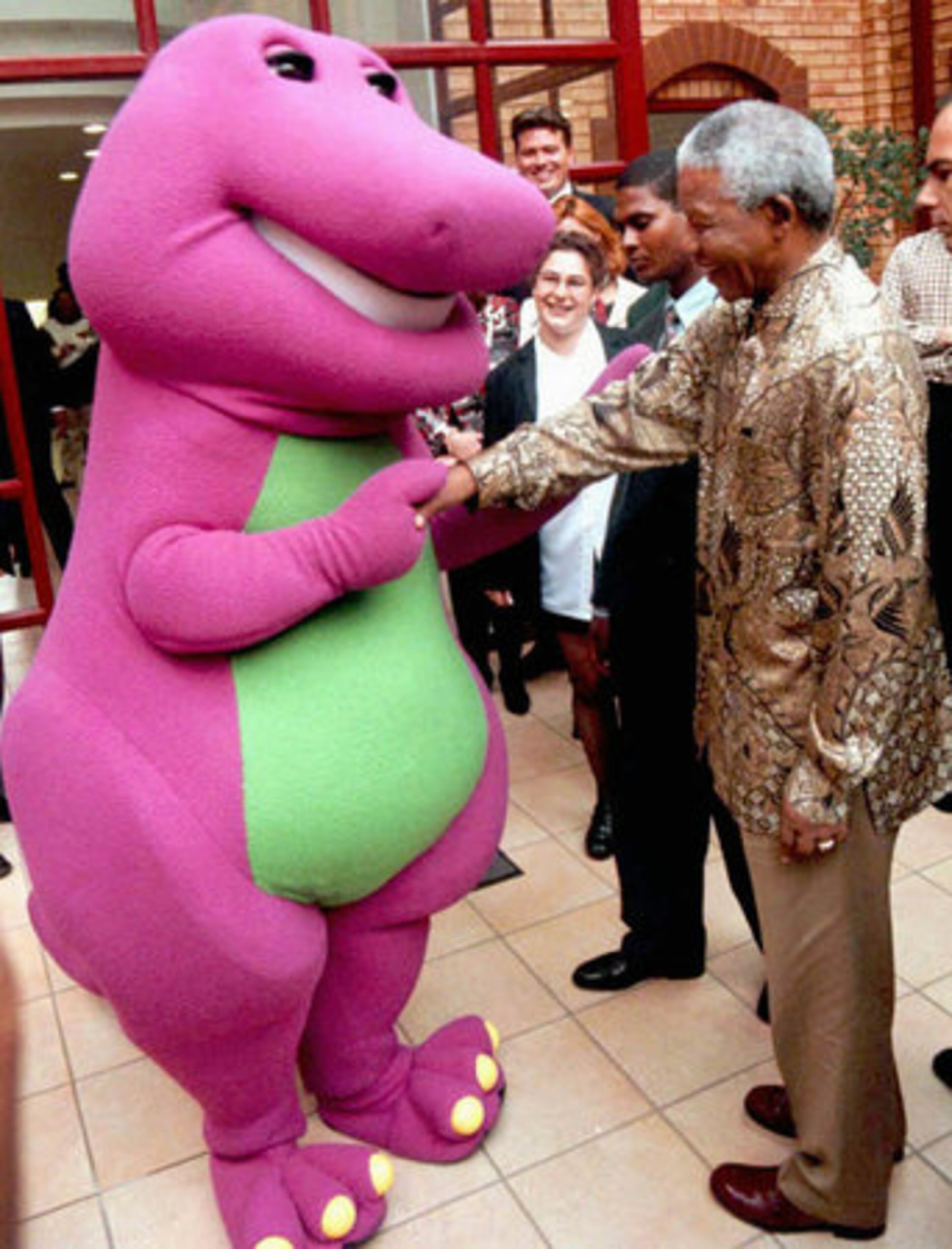 Barney is greeted by South African President Nelson Mandela in Johannesburg on March 24, 1997.