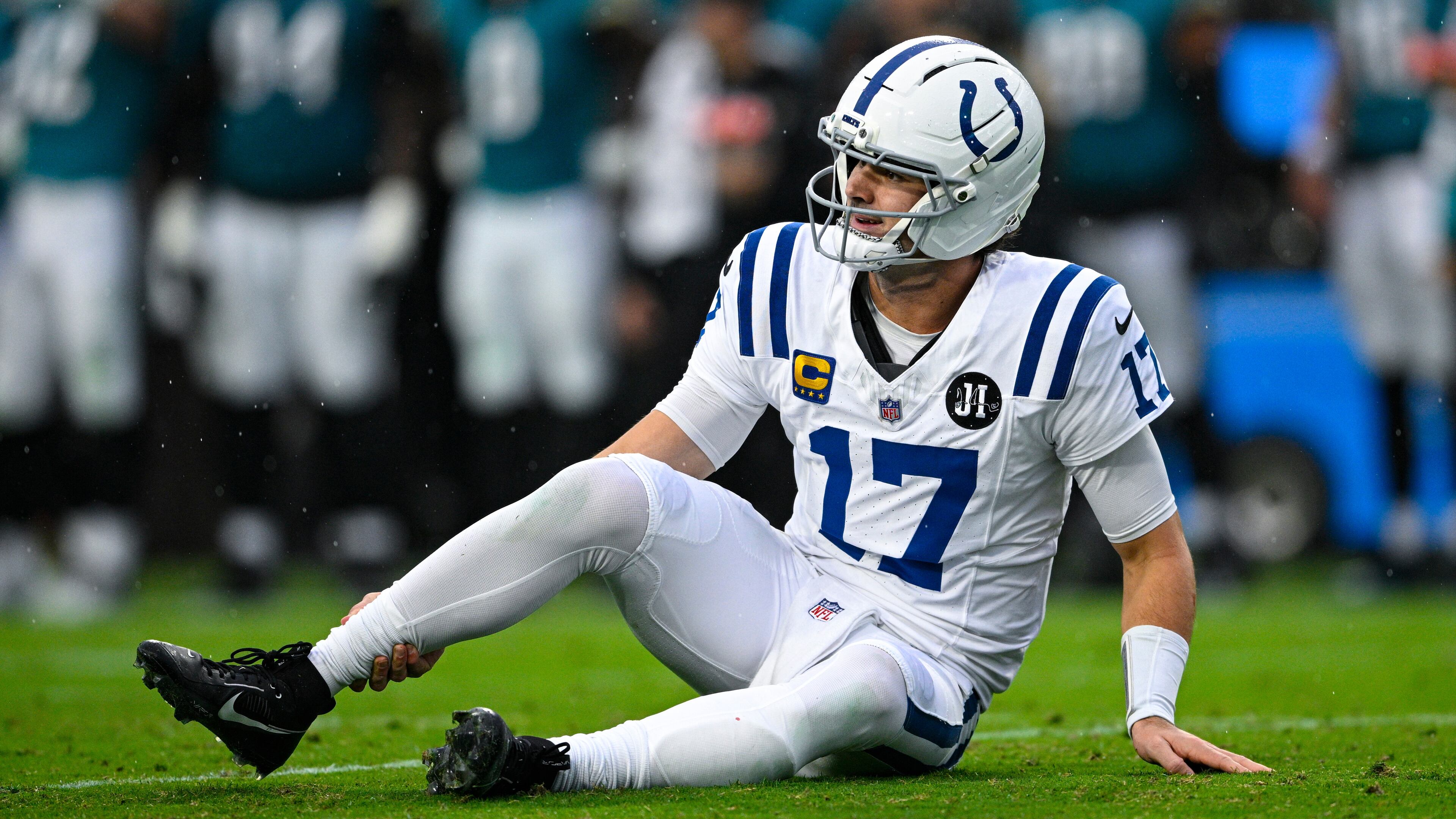 Indianapolis Colts quarterback Daniel Jones (17) grabs his leg after an injury during the first half of an NFL football game against the Jacksonville Jaguars, Sunday, Dec. 7, 2025, in Jacksonville, Fla. (AP Photo/Phelan M. Ebenhack)