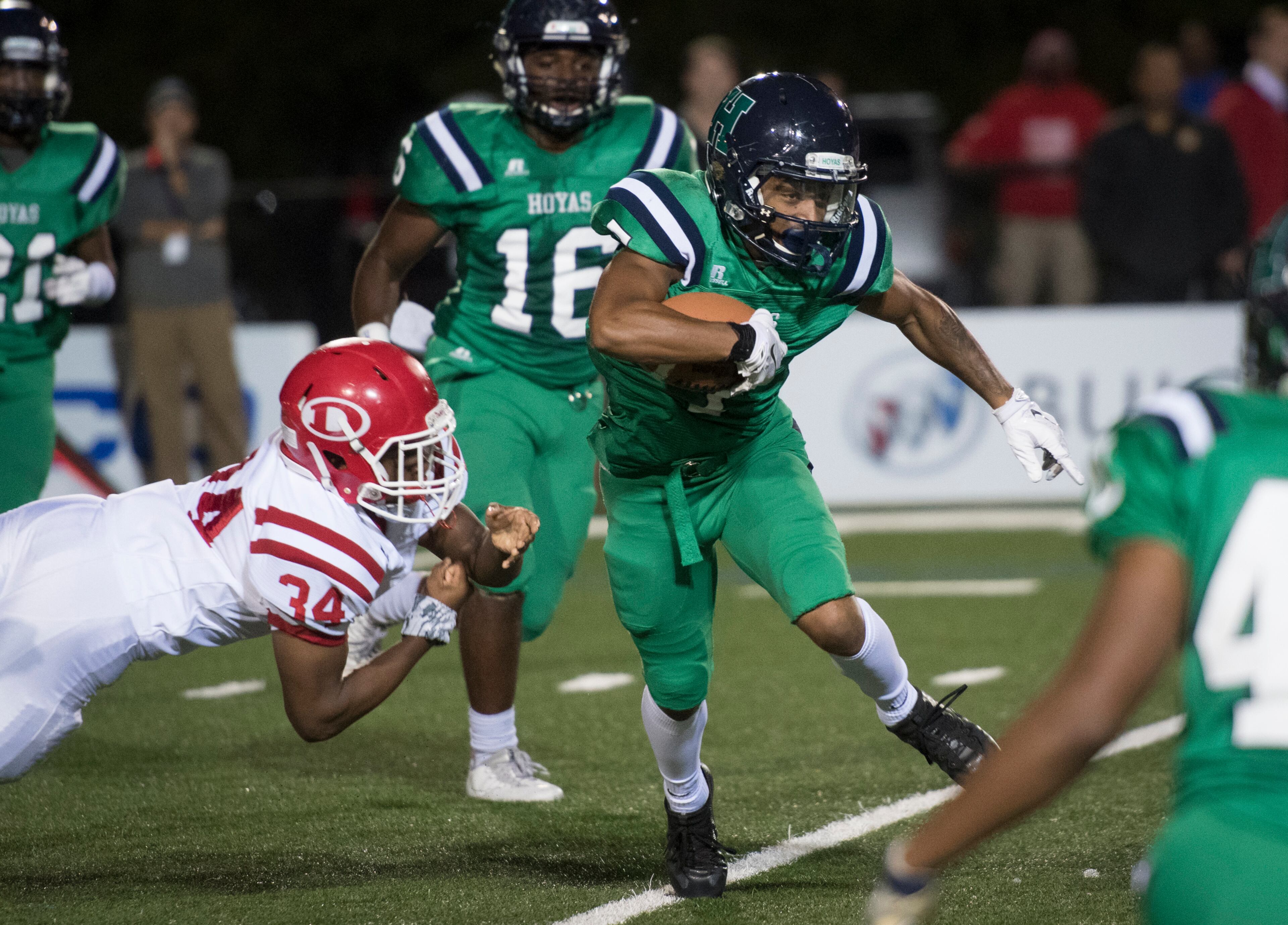 Harrison wide receiver Dawson Brown runs as Dalton's Joshua Moore (34) goes for the tackle during a high school football game on Thursday, Oct. 19, 2017, in Kennesaw, Ga. (Special to the Atlanta Journal-Constitution, John Amis )