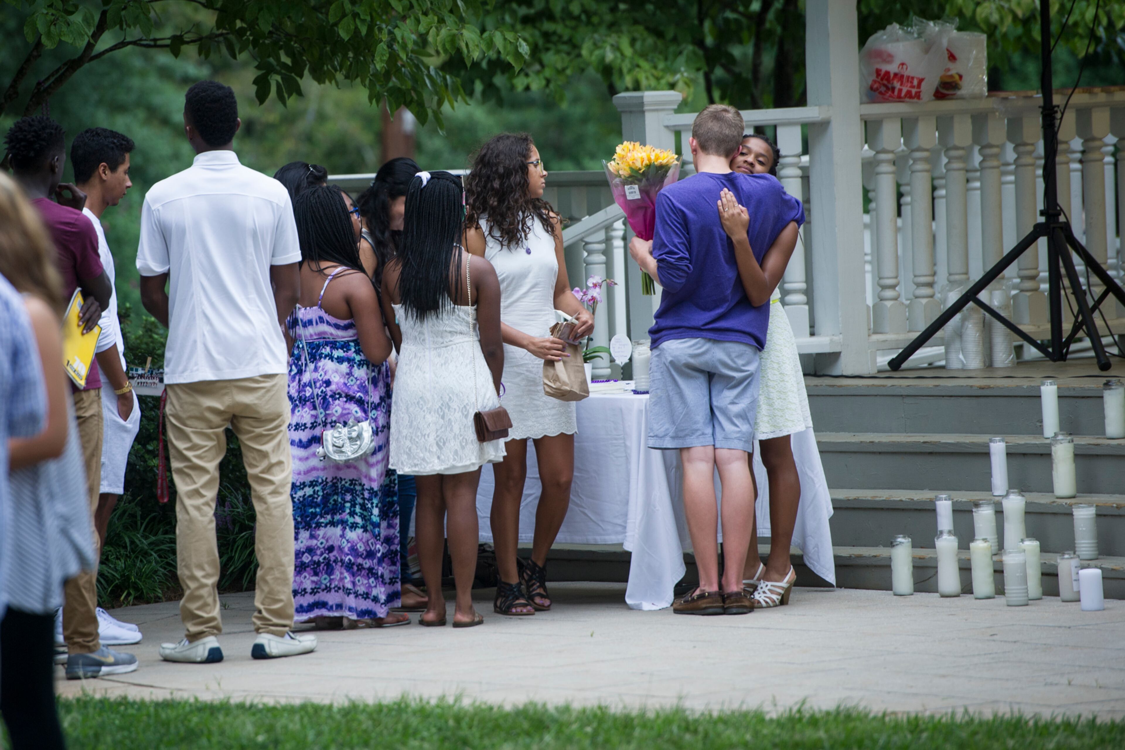 Friends of Natalie Henderson hug during a vigil held for her on the old Roswell Square, Thursday, Aug. 4, 2016. Henderson and Carter Davis of Woodstock, both 17, were found Monday, Aug. 1, 2016, behind a Publix, grocery store shot to death. Jeffrey A. Hazelwood, 20, was arrested Wednesday and will be charged with two counts of murder in the deaths. (Photo Contributed by John Amis)