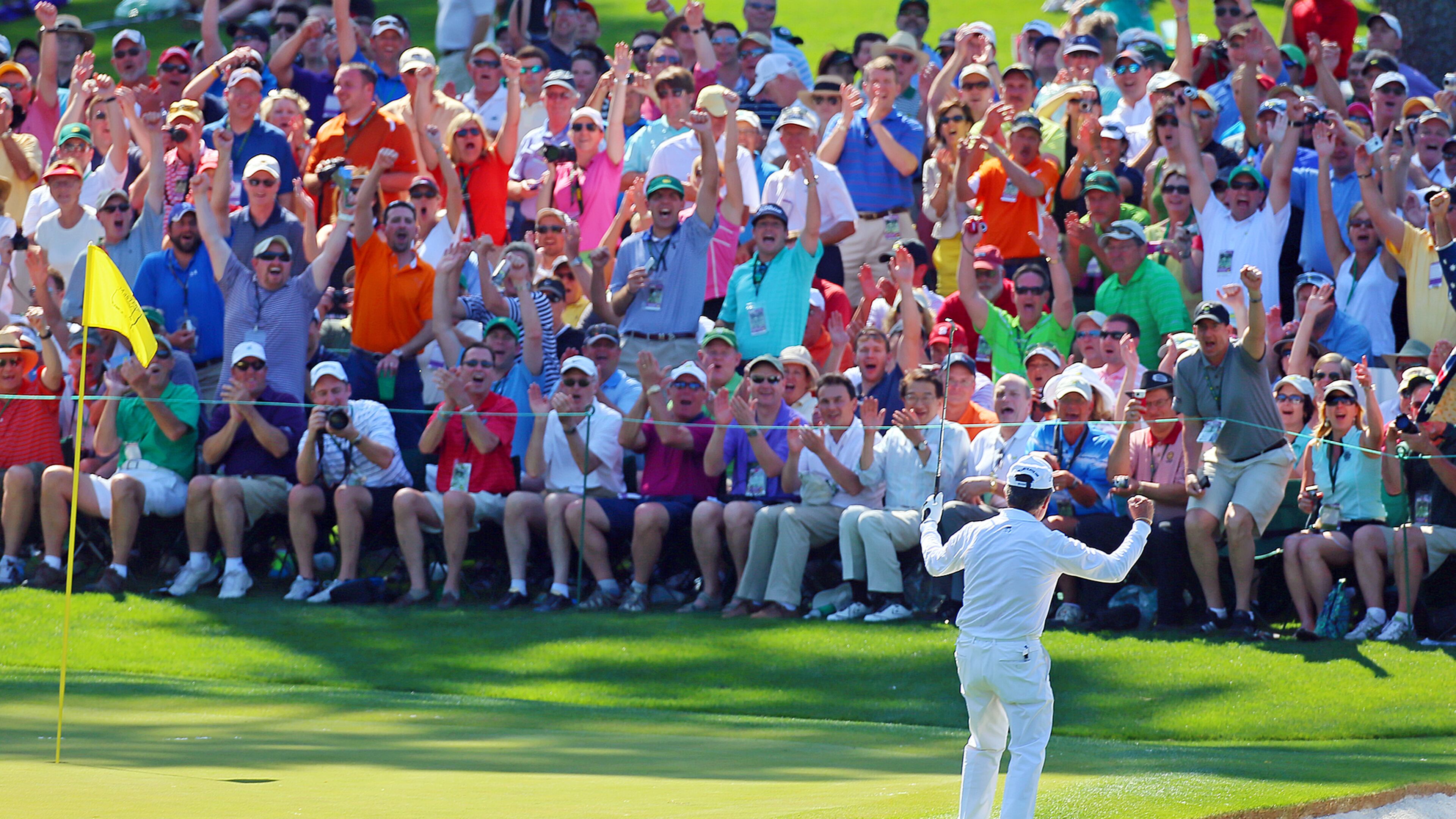 It's another Masters moment as three time champion Gary Player and the gallery react as he chips it in the hole at the 6th green.
