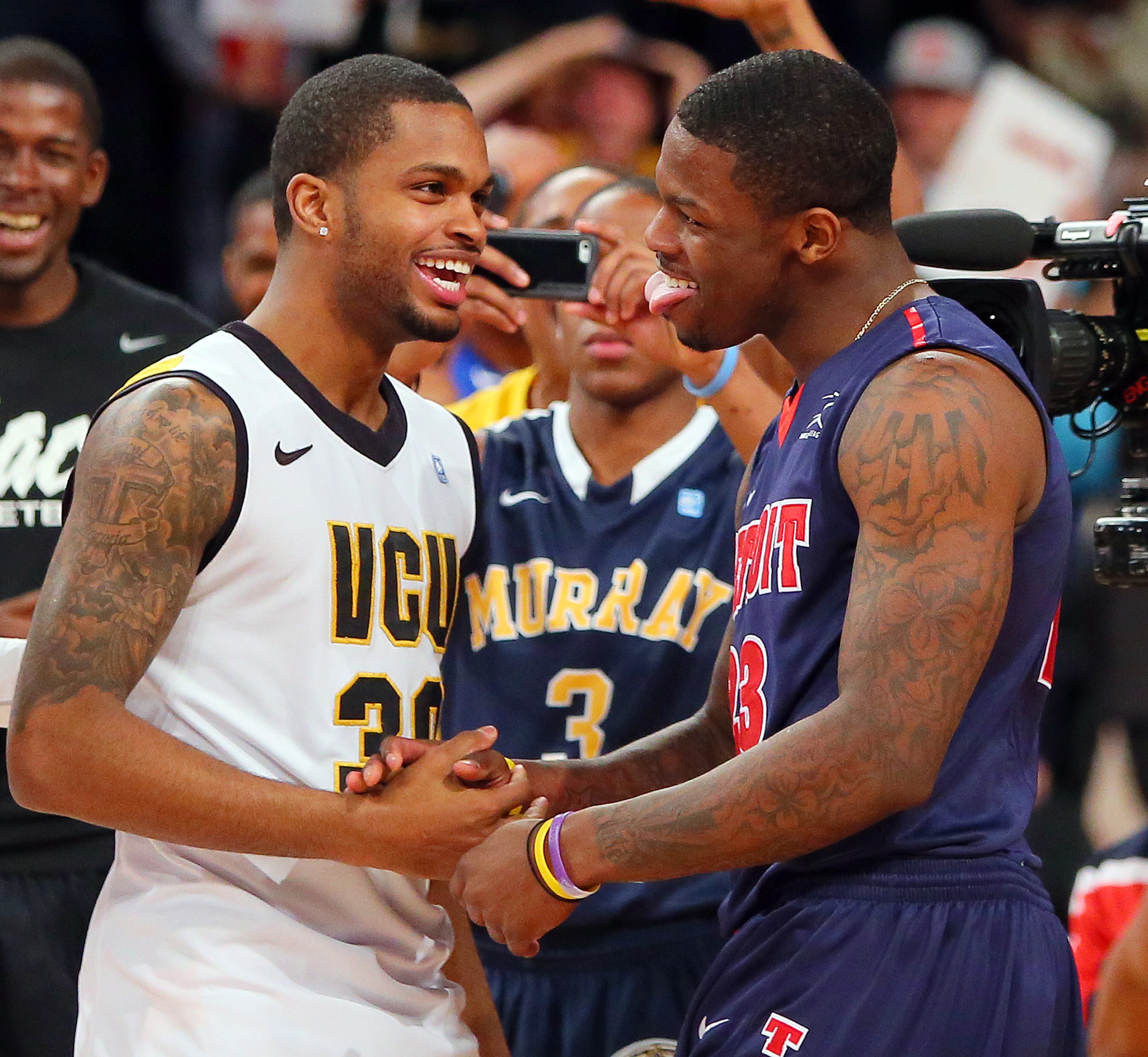 Men's Three-Point Champion Troy Daniels (left), VCU, and Slam Dunk Champion Doug Anderson (right), University of Detroit Mercy, celebrate their victorys at the 25th annual State Farm College Slam Dunk & 3-Point Championships at McCamish Pavilion on Thursday, April 4, 2013, in Atlanta. CURTIS COMPTON / CCOMPTON@AJC.COM
