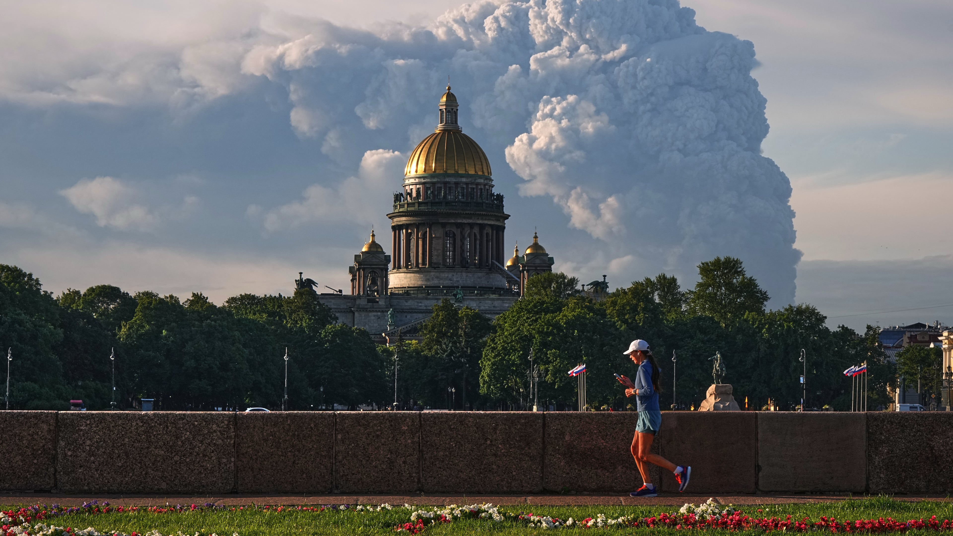 FILE - Smoke rises following a Ukrainian drone attack on a warehouse for online retailer Wildberries in St. Petersburg, Russia on Friday, July 24, 2026, with St. Isaac's Cathedral seen in foreground. (UGC via AP, File)
