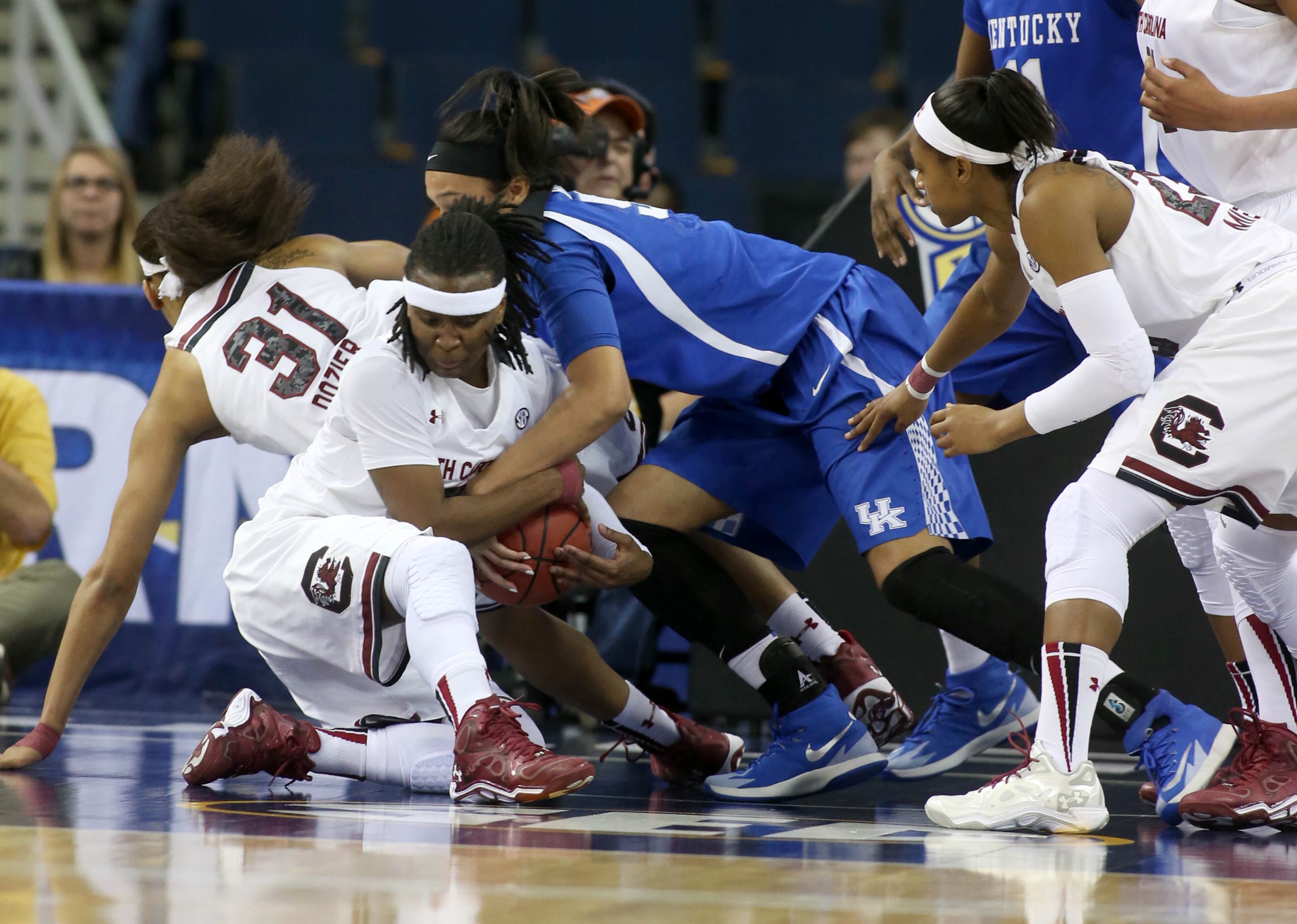 South Carolina guard Khadijah Sessions (5) and Kentucky forward/center Azia Bishop (50) fight for a loose ball during the first half an NCAA college basketball game in the semifinals of the Southeastern Conference women's basketball tournament, Saturday, March 8, 2014, in Duluth, Ga.