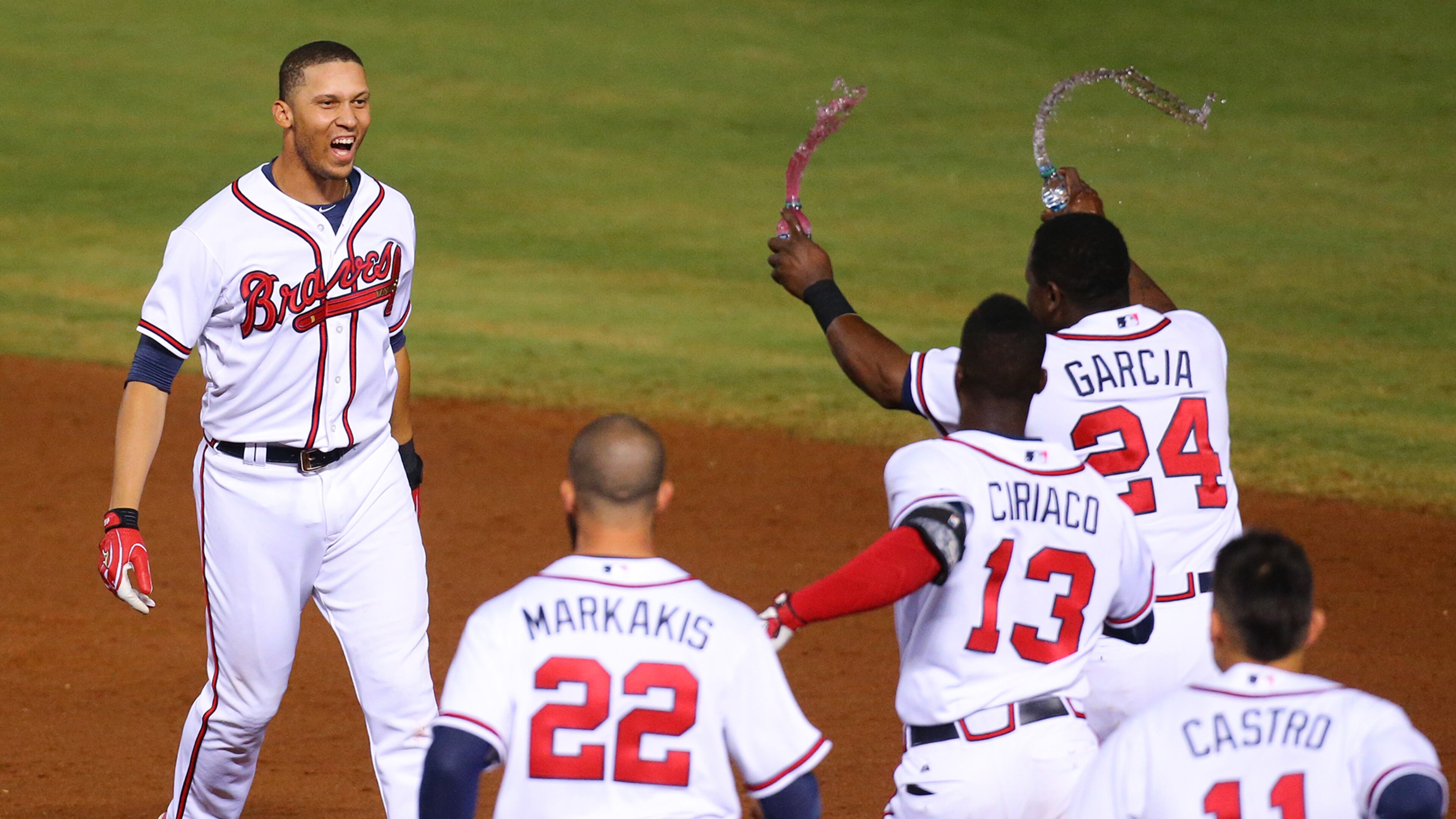 Braves teammates charge Andrelton Simmons after he hit a walk-off game-winning RBI single to beat Toronto 3-2 in September. Simmons was traded to the Los Angeles Angels Friday night. (Curtis Compton / ccompton@ajc.com)
