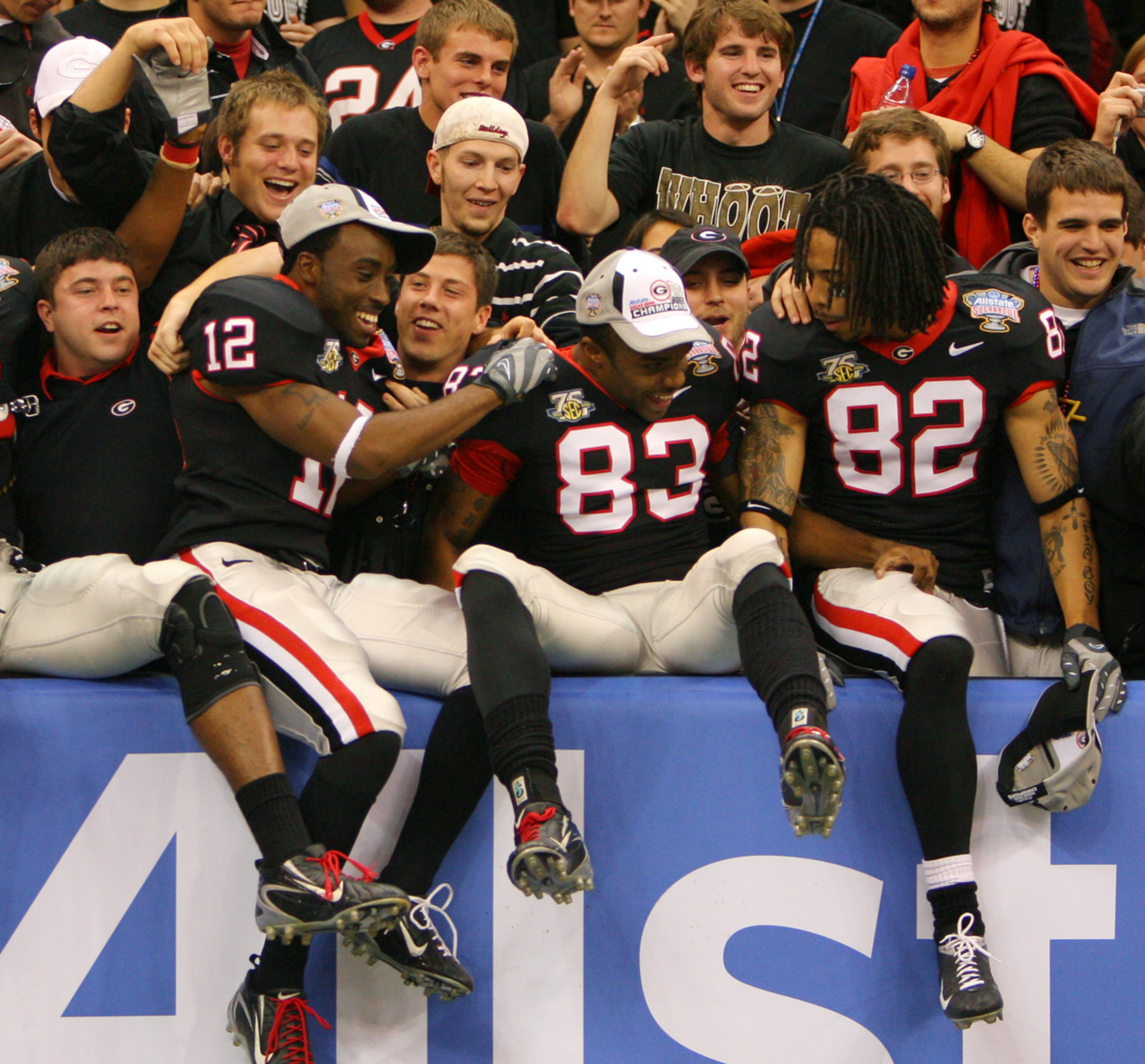 Georgia linebacker Brandon Miller (12), Georgia split end T.J. Gartrell (83) and Georgia flanker Mike Moore (82) celebrate their 41-10 win with Bulldog fans in UGA vs. Hawaii Allstate Sugar Bowl game in the Superdome Tuesday 1/1/08. BRANT SANDERLIN / Staff