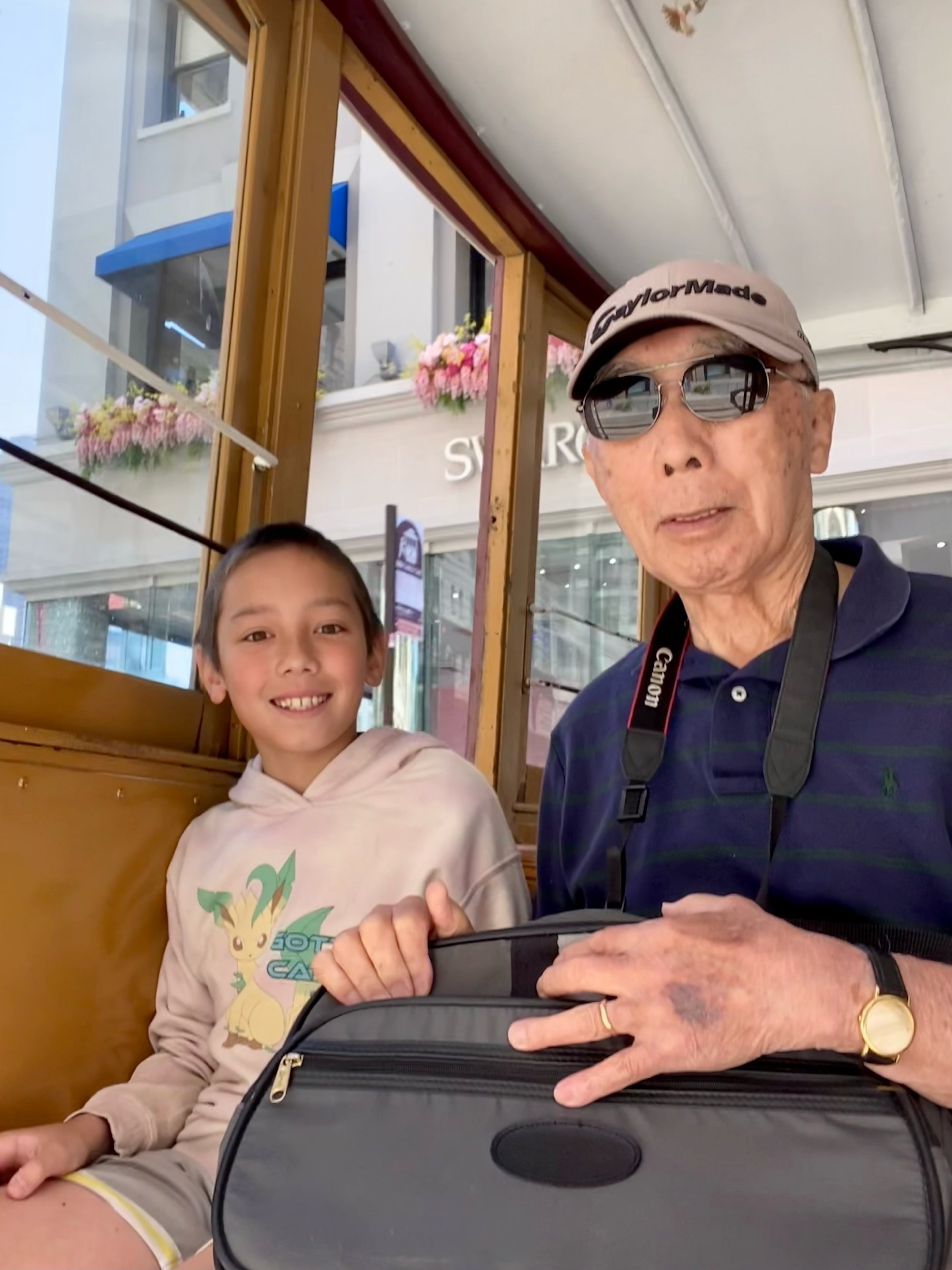 A photo of my father, Go Sugiura, with my son, Kai, on a San Francisco cable car in 2024. (Ken Sugiura/AJC)