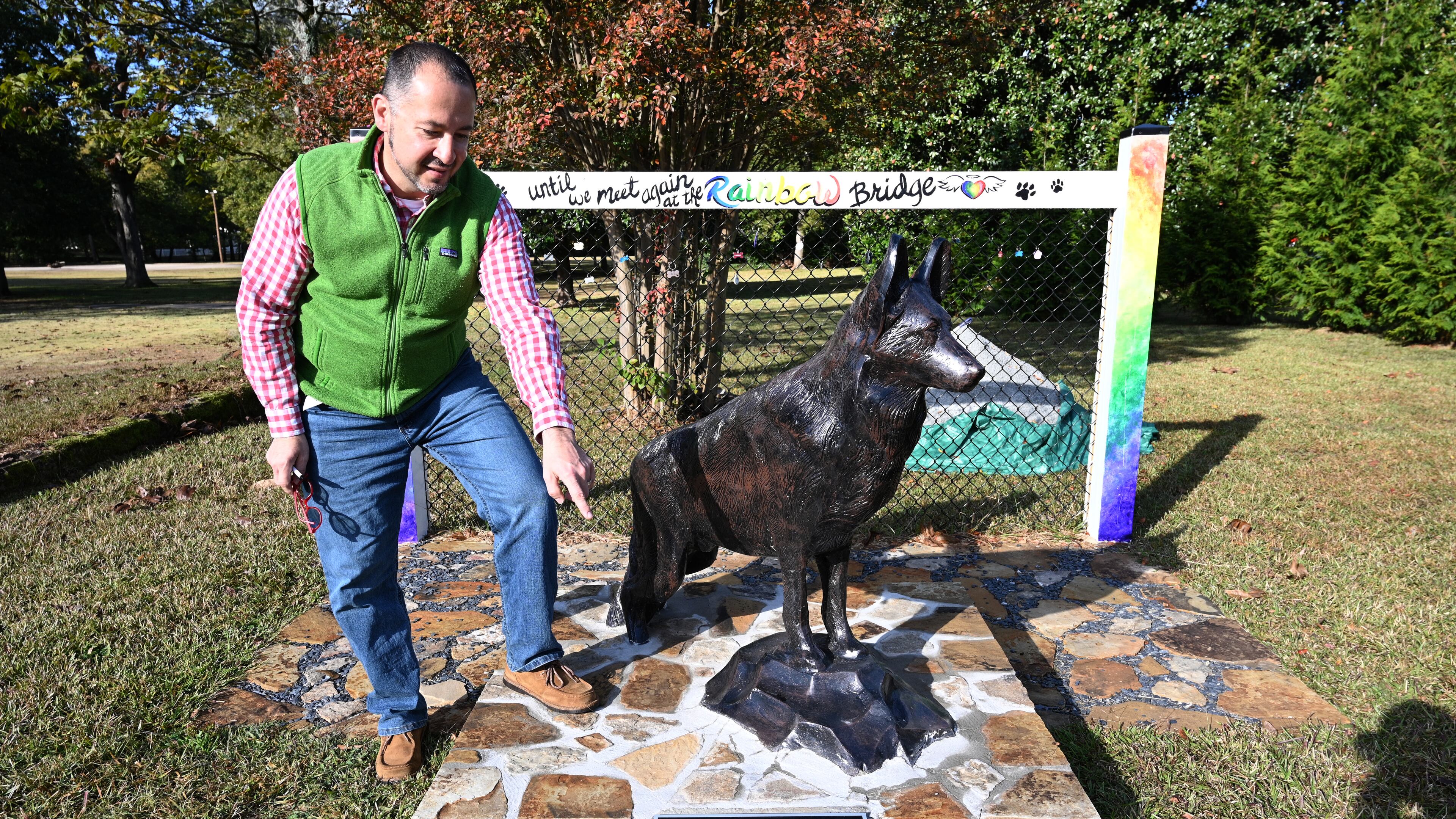 A bronze statue celebrates the German shepherd Ace, near the offices of Fallas Family Vision in McDonough. When Dr. Humberto Fallas created a memorial for his dog, who died suddenly last spring, he also included a place for other grieving pet owners leave a remembrance of their animal companions. About a dozen or so other pet owners have hung their pets' dogtags (and cat-tags) up at the site, memorializing animal friends who have passed away.(Hyosub Shin / Hyosub.Shin@ajc.com)
